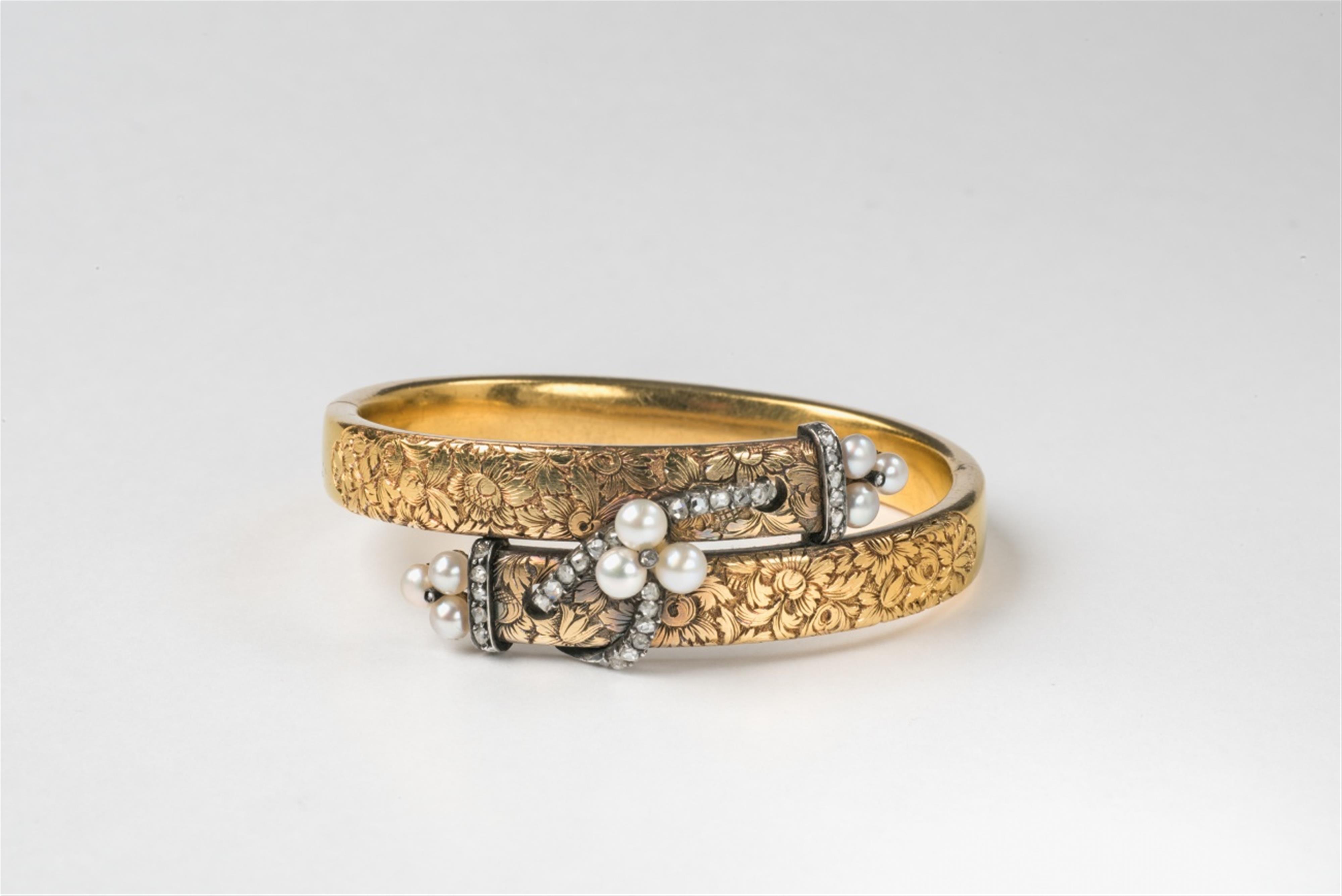 An 18k gold natural pearl and diamond Napoleon III crossover bangle - image-1
