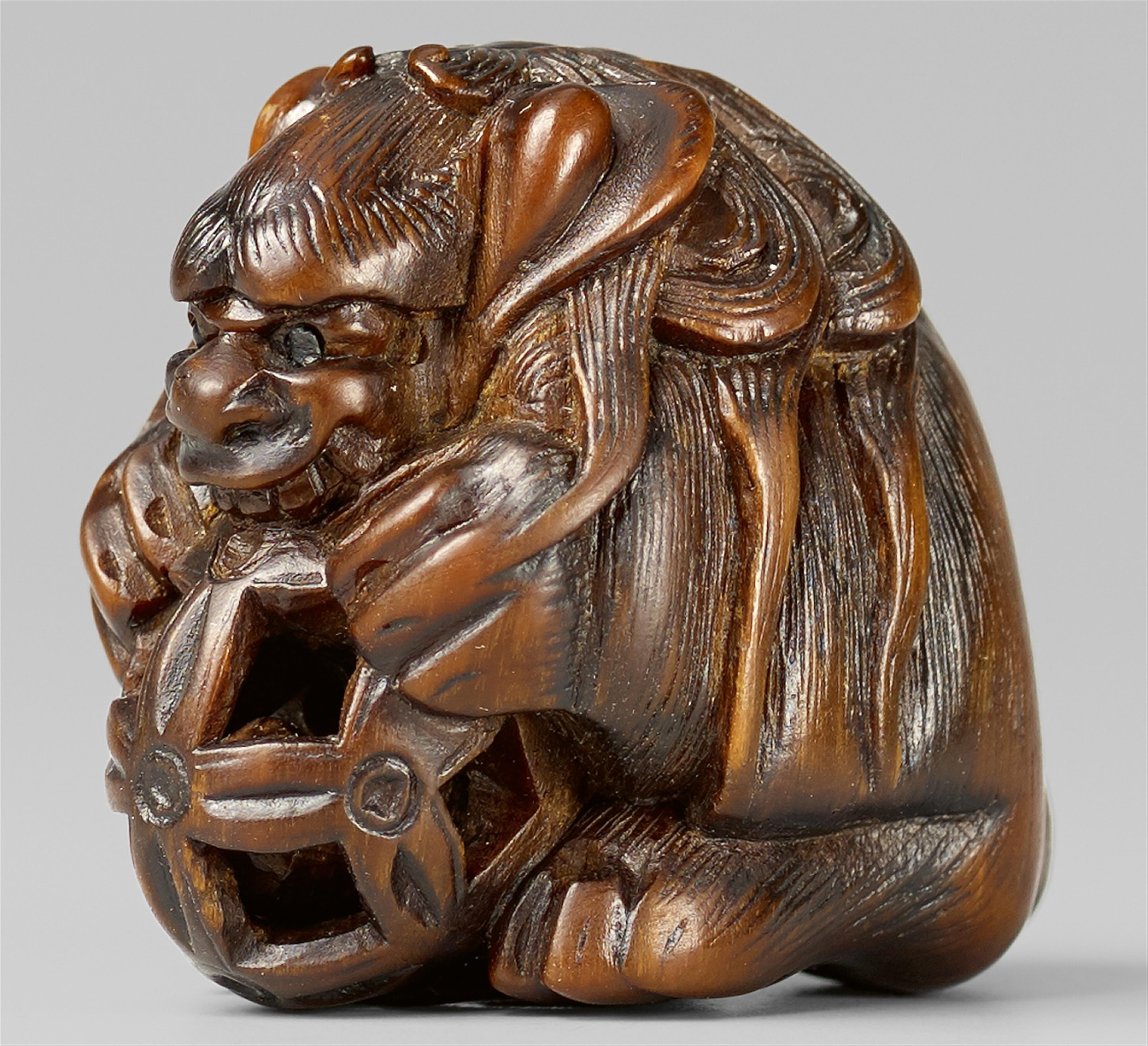 A boxwood netsuke of a shishi with a ball. 19th century - image-1