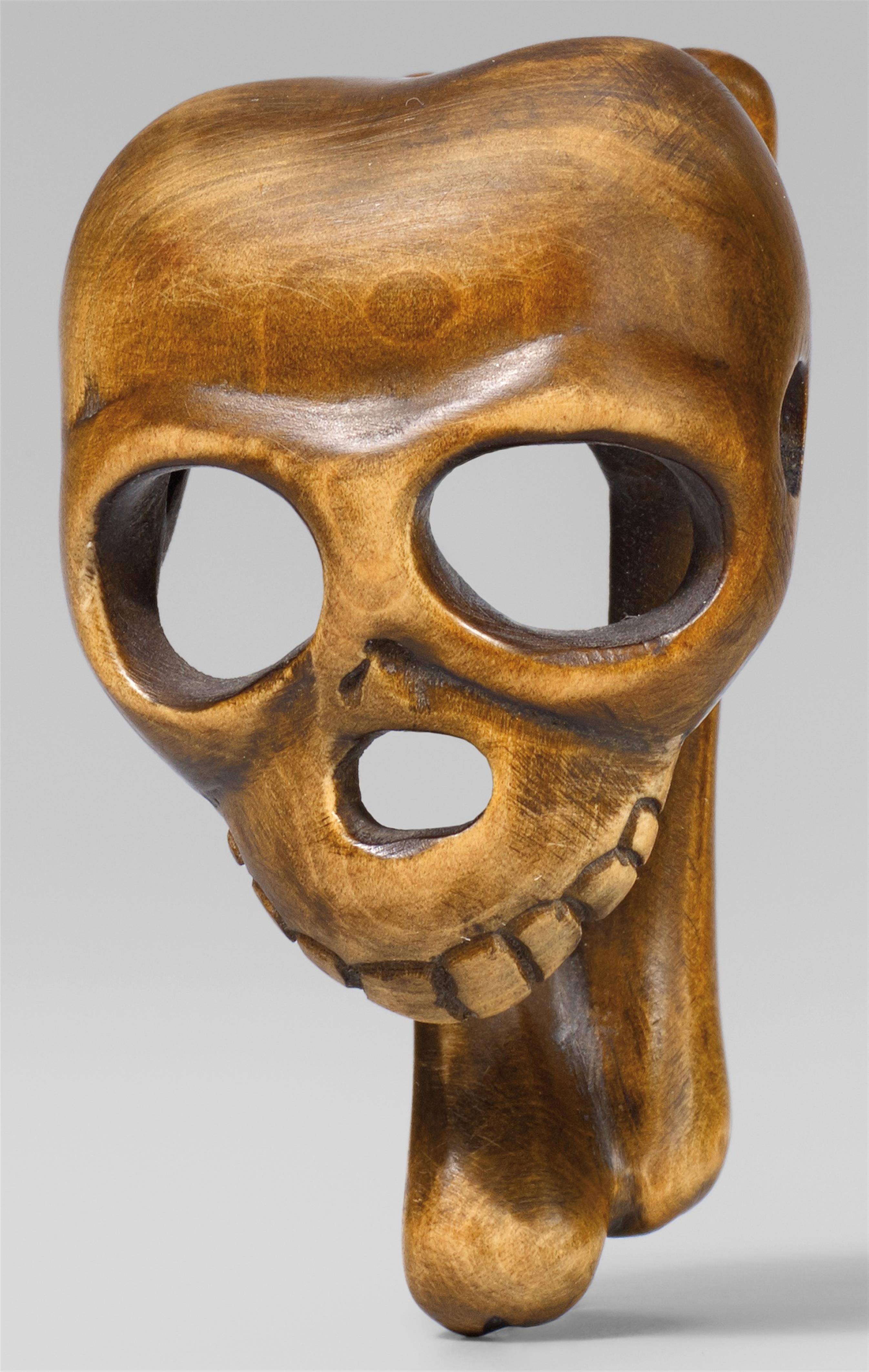 A macabre boxwood netsuke of a skull. 20th century - image-1