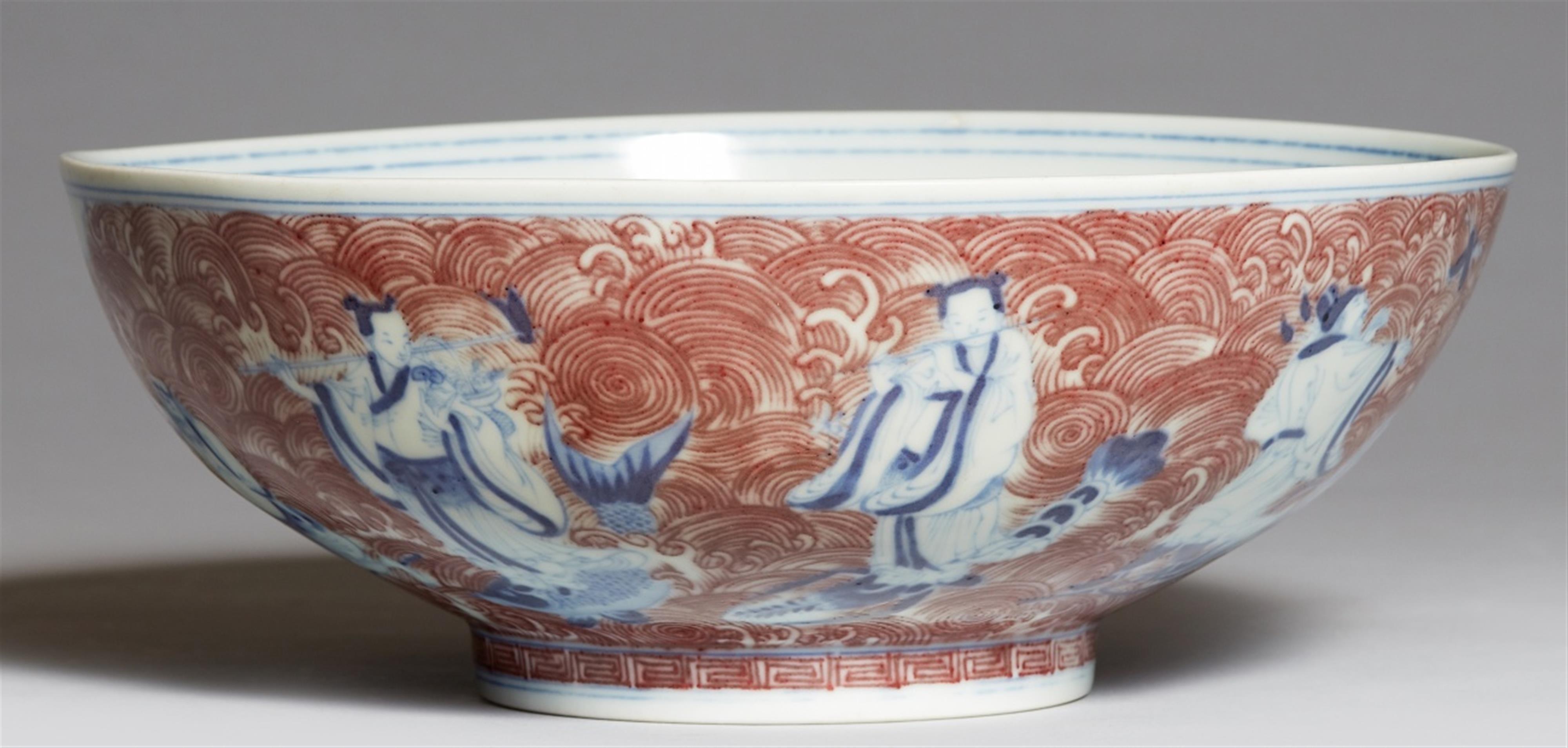 A copper-red-decorated blue and white Eight Immortals bowl. 19th/20th centry - image-1