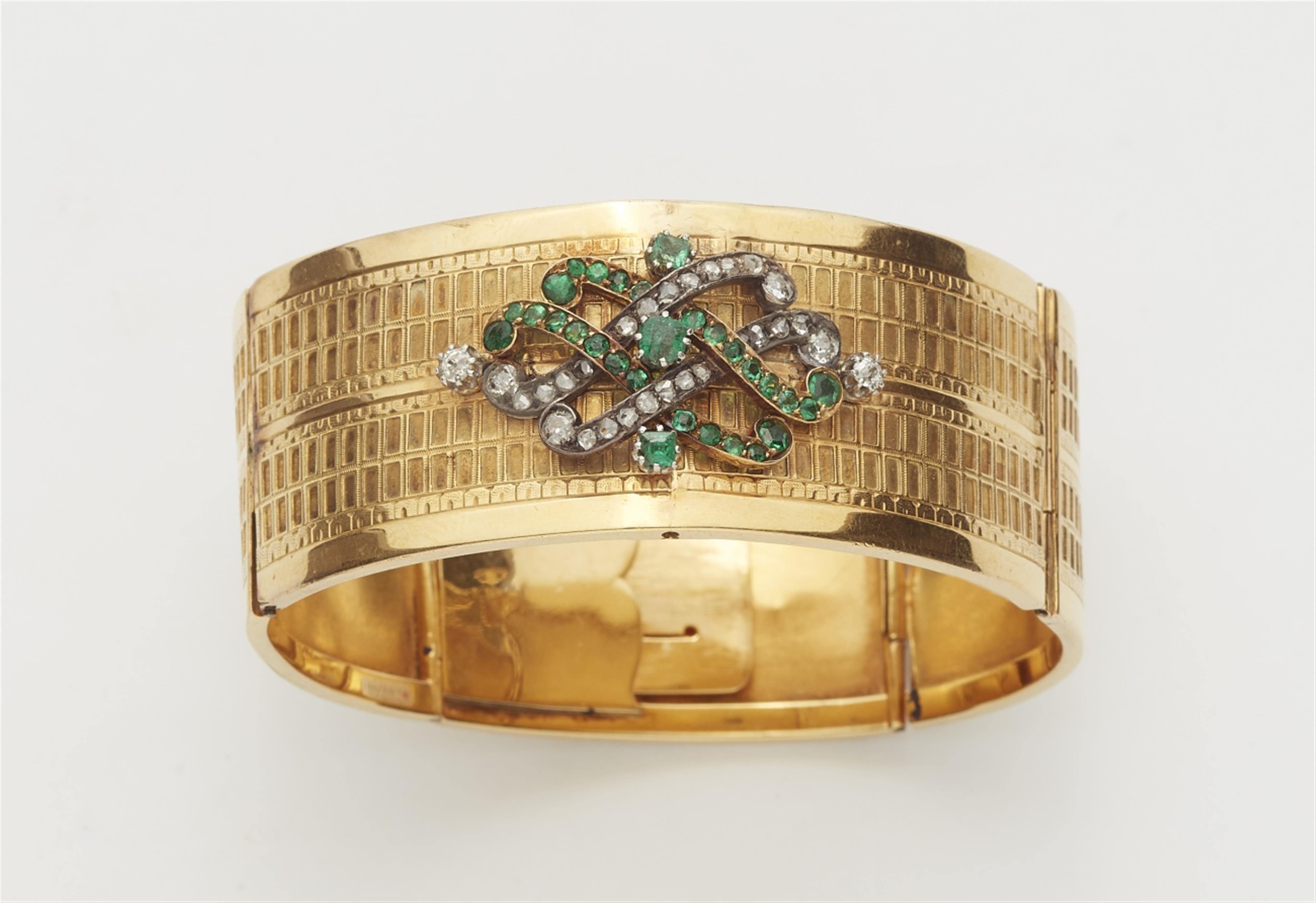 An 18k gold and emerald bangle - image-1