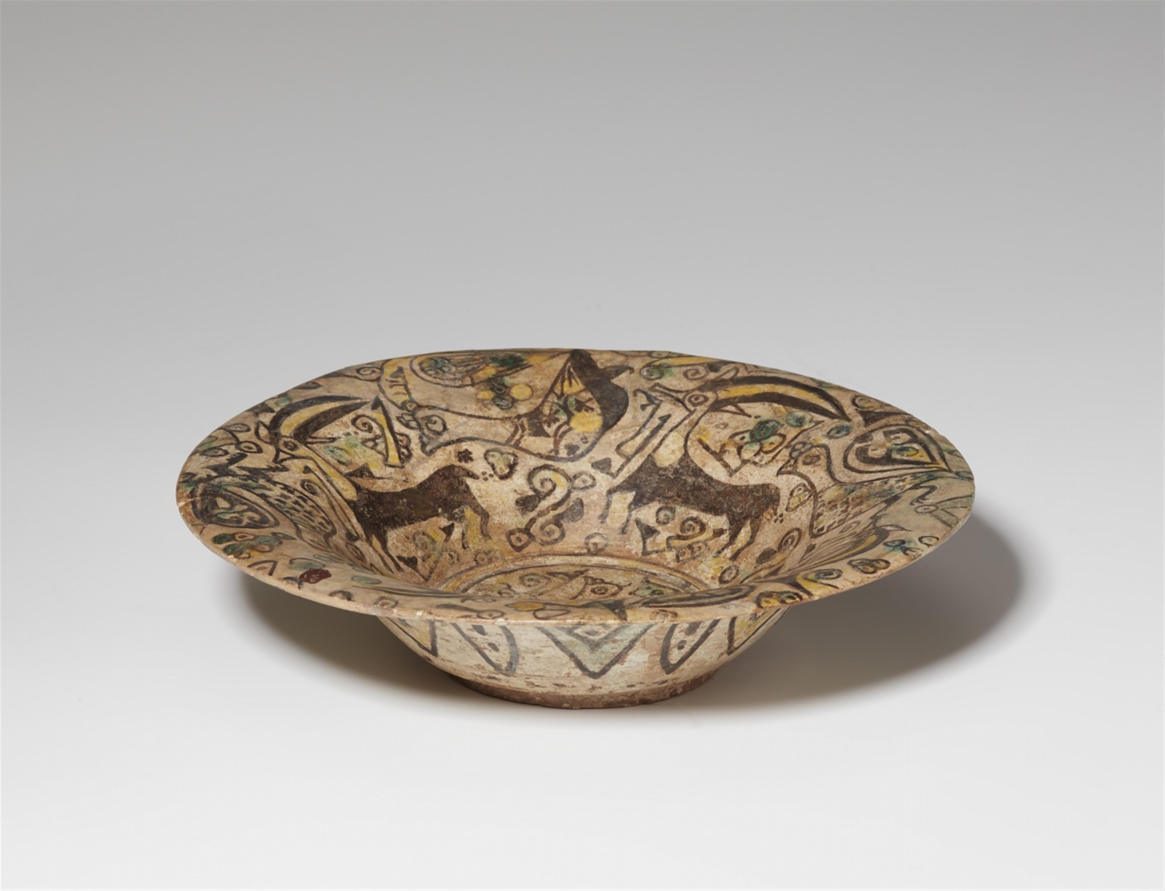 An East Iranian fritware dish with peacocks and ibexes - image-2