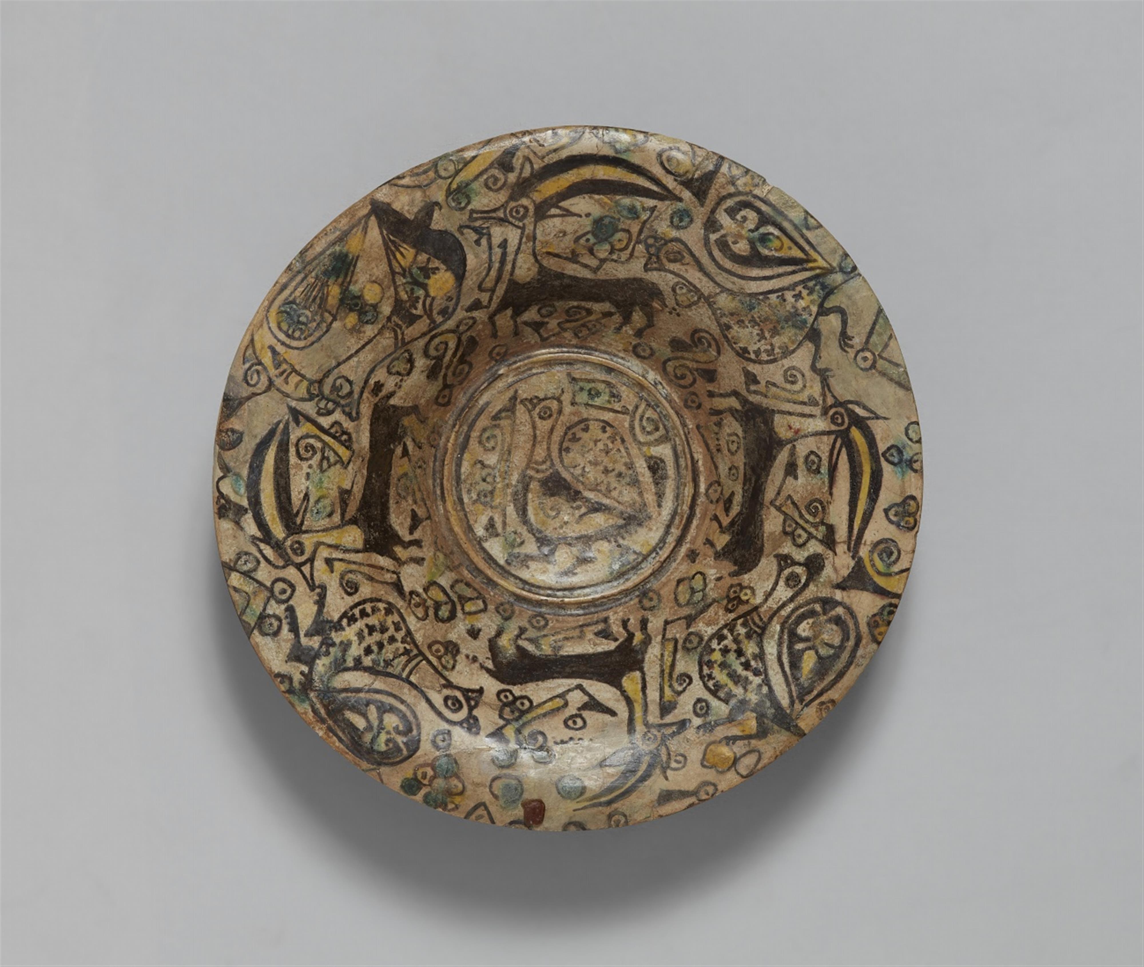 An East Iranian fritware dish with peacocks and ibexes - image-1