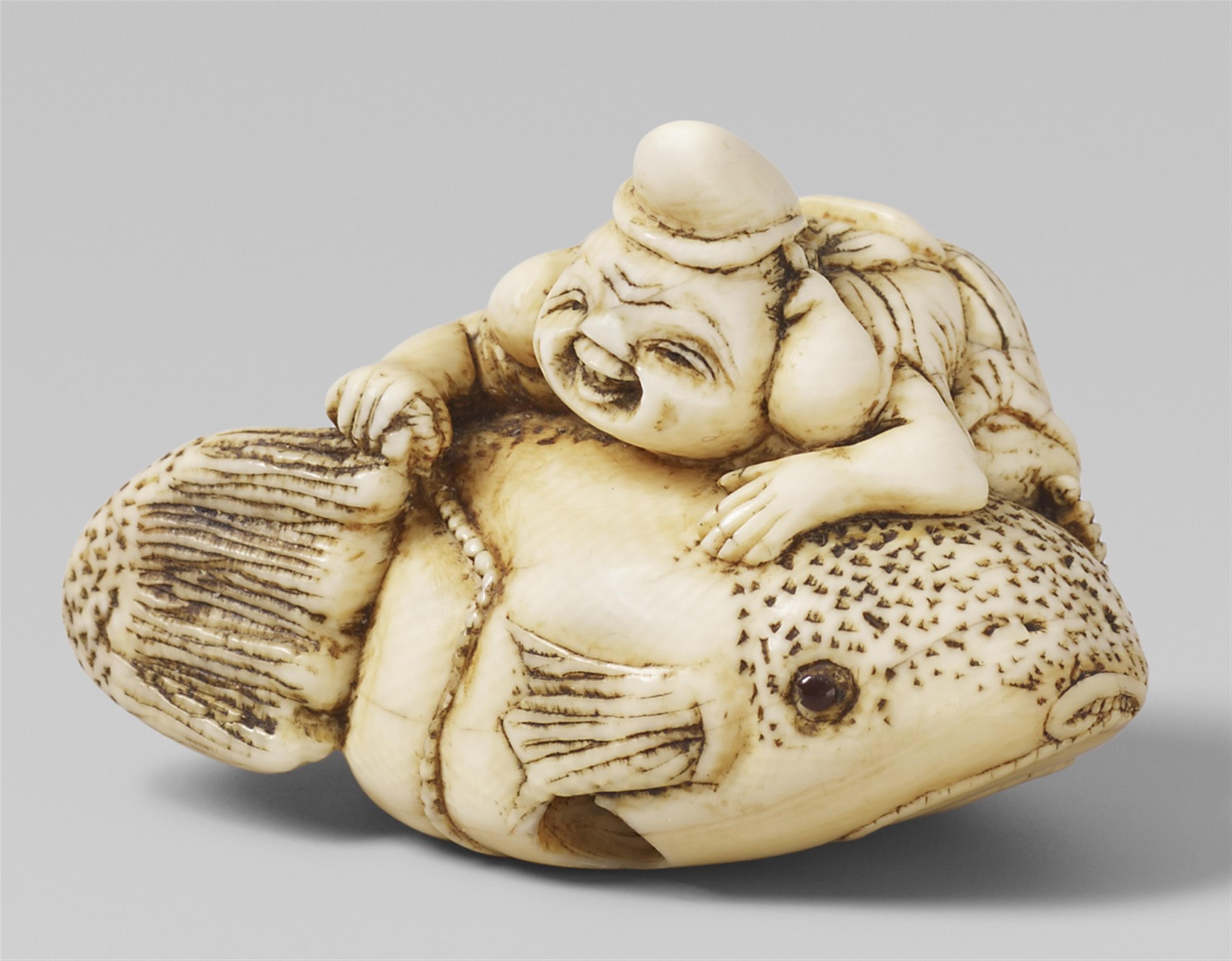 An ivory netsuke of Ebisu climbing over a big fugu fish. Late 18th century - image-1