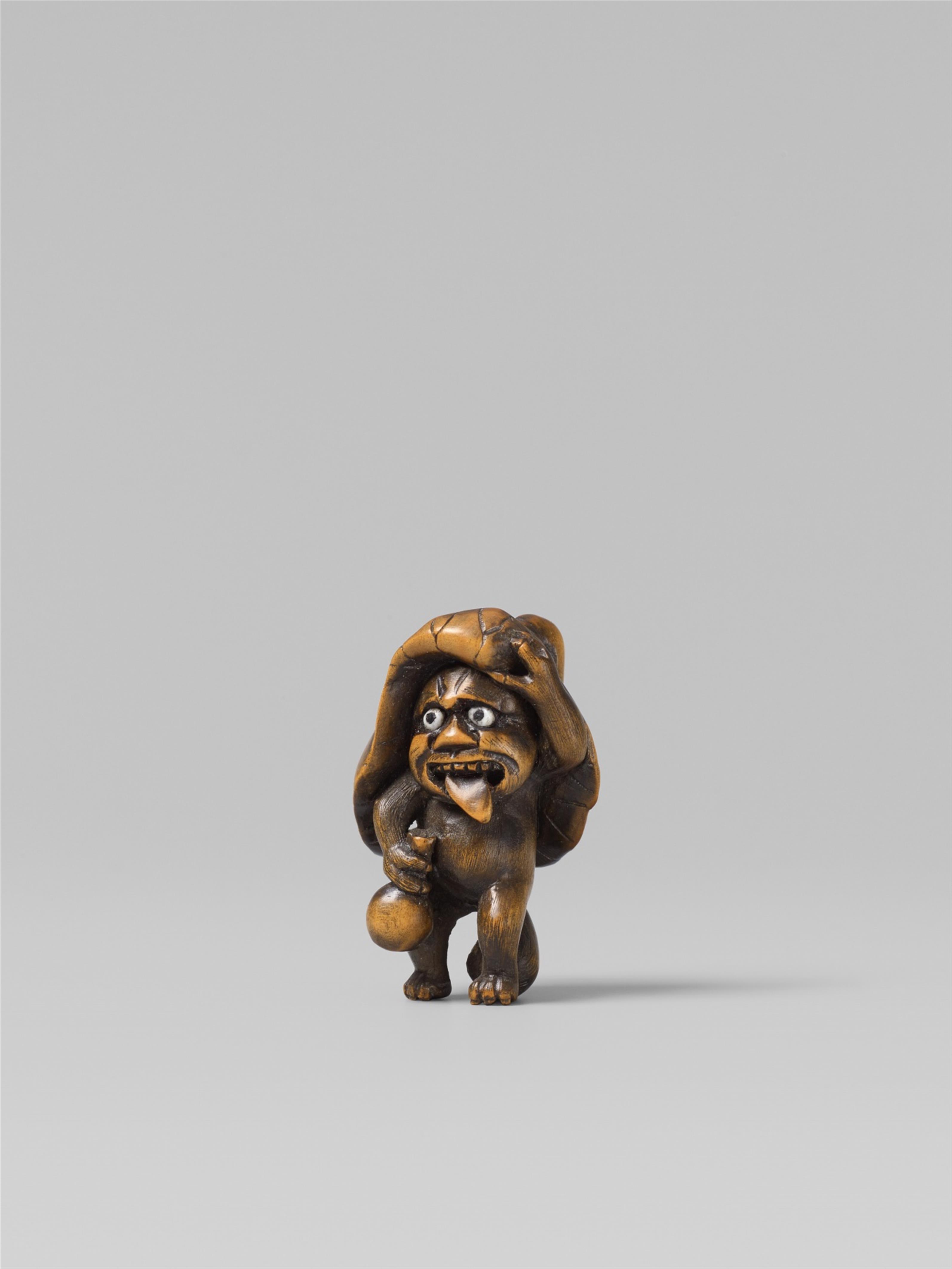 A boxwood netsuke of a drunk tanuki. Late 19th century - image-1