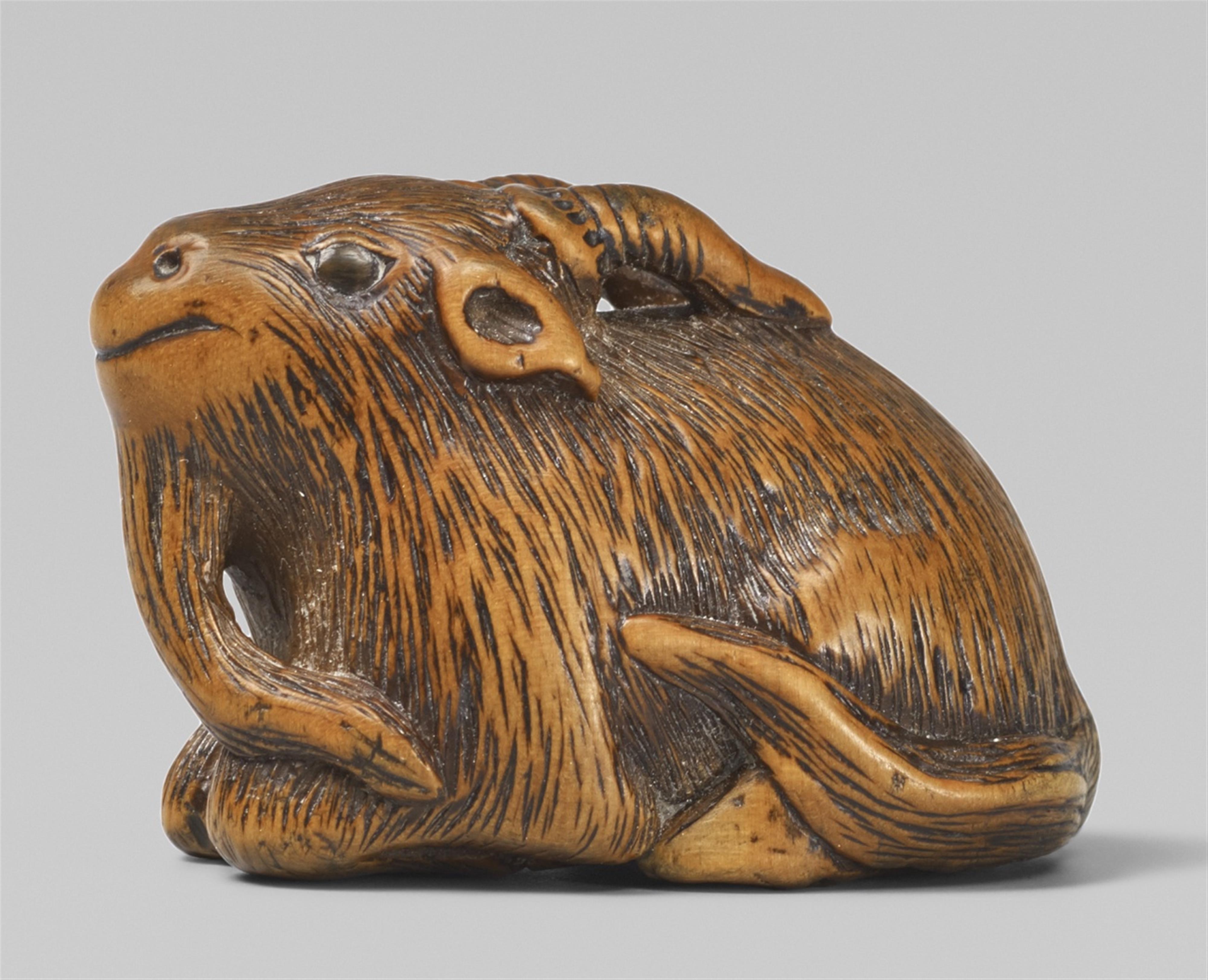 A boxwood netsuke of a recumbent goat. Mid-19th century - image-1