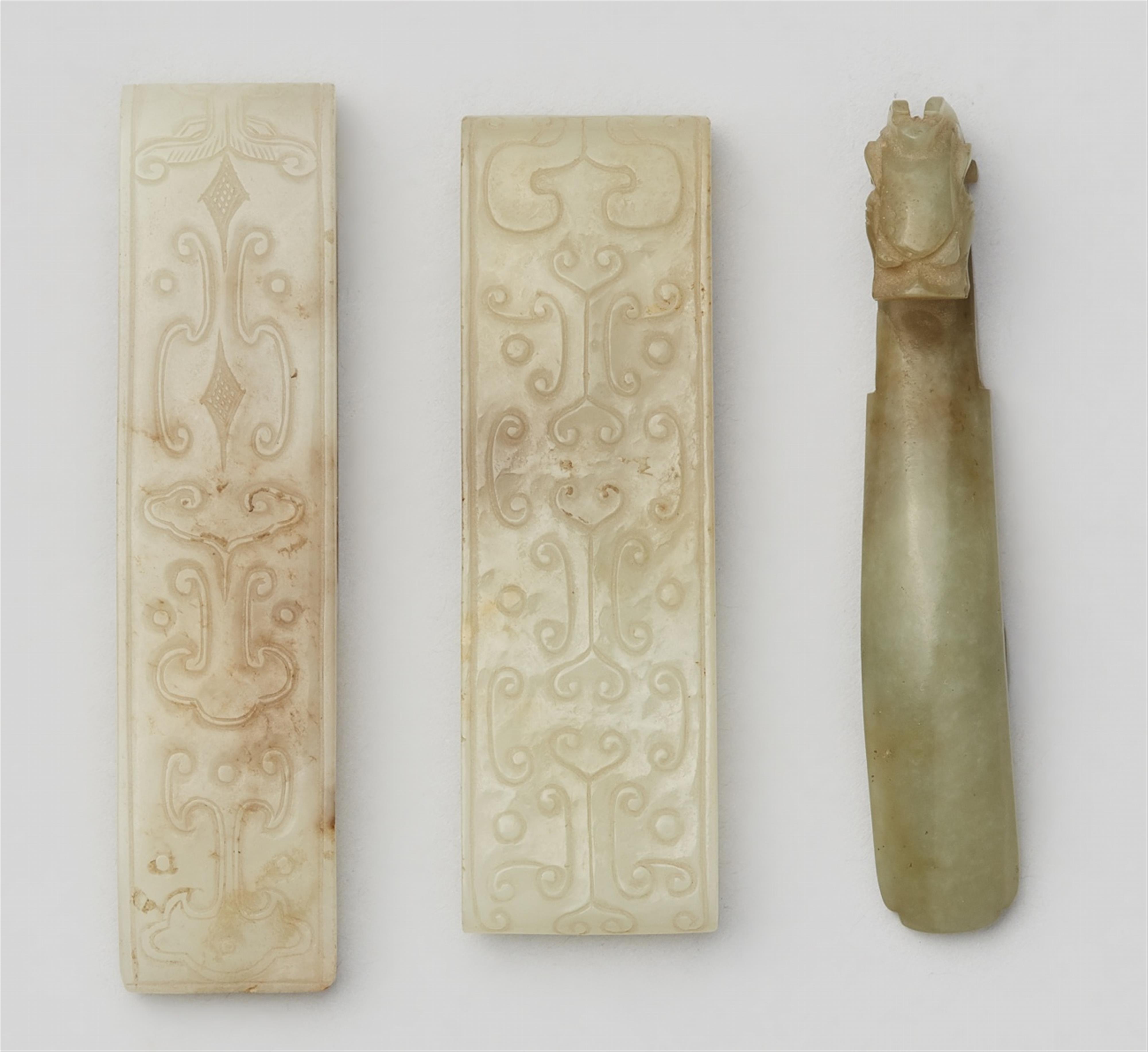 Two seladon-coloured scabbard slides and a jade belt hook. Han dynasty or later - image-1