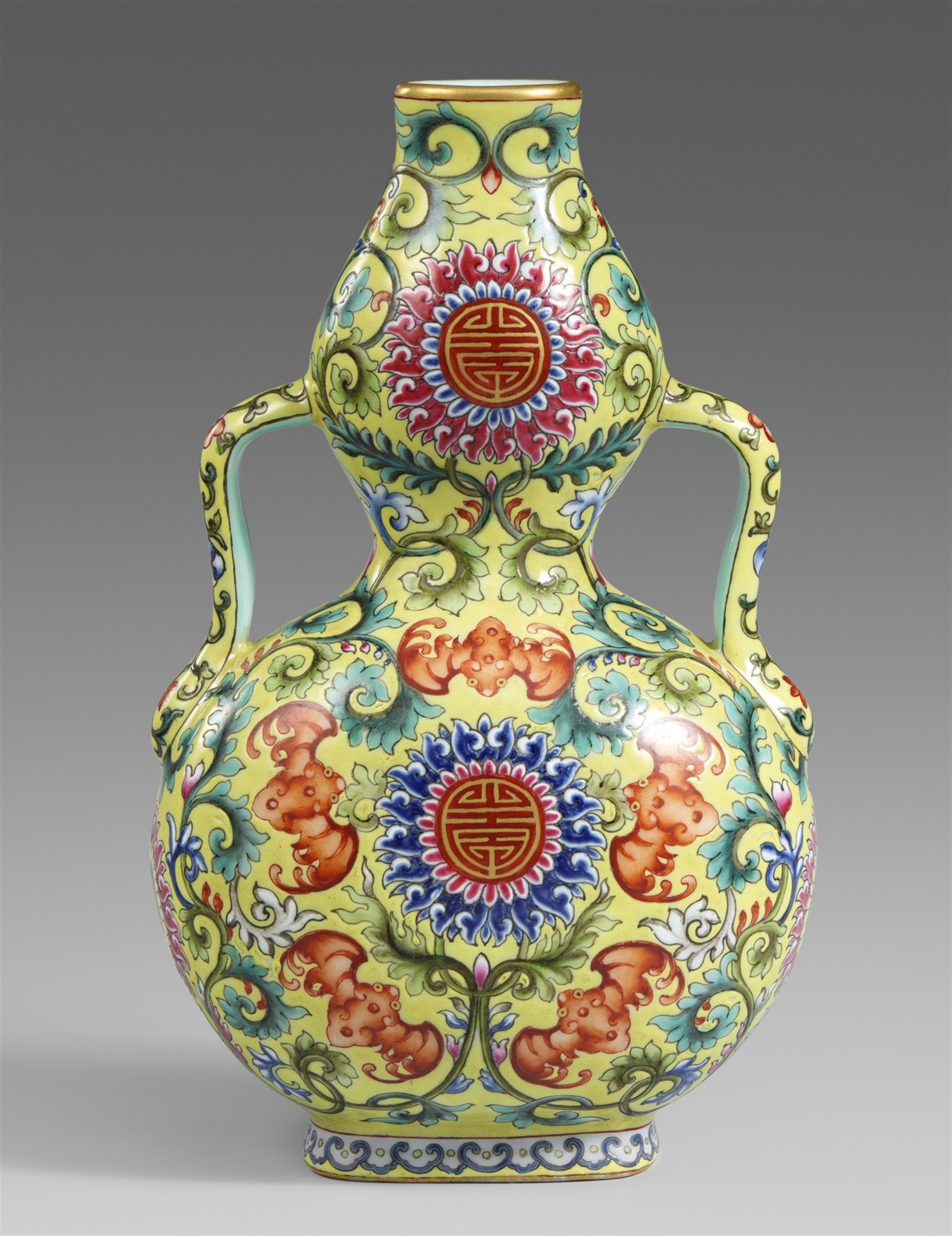 A yellow ground famille rose double-gourd vase. 20th century - image-1