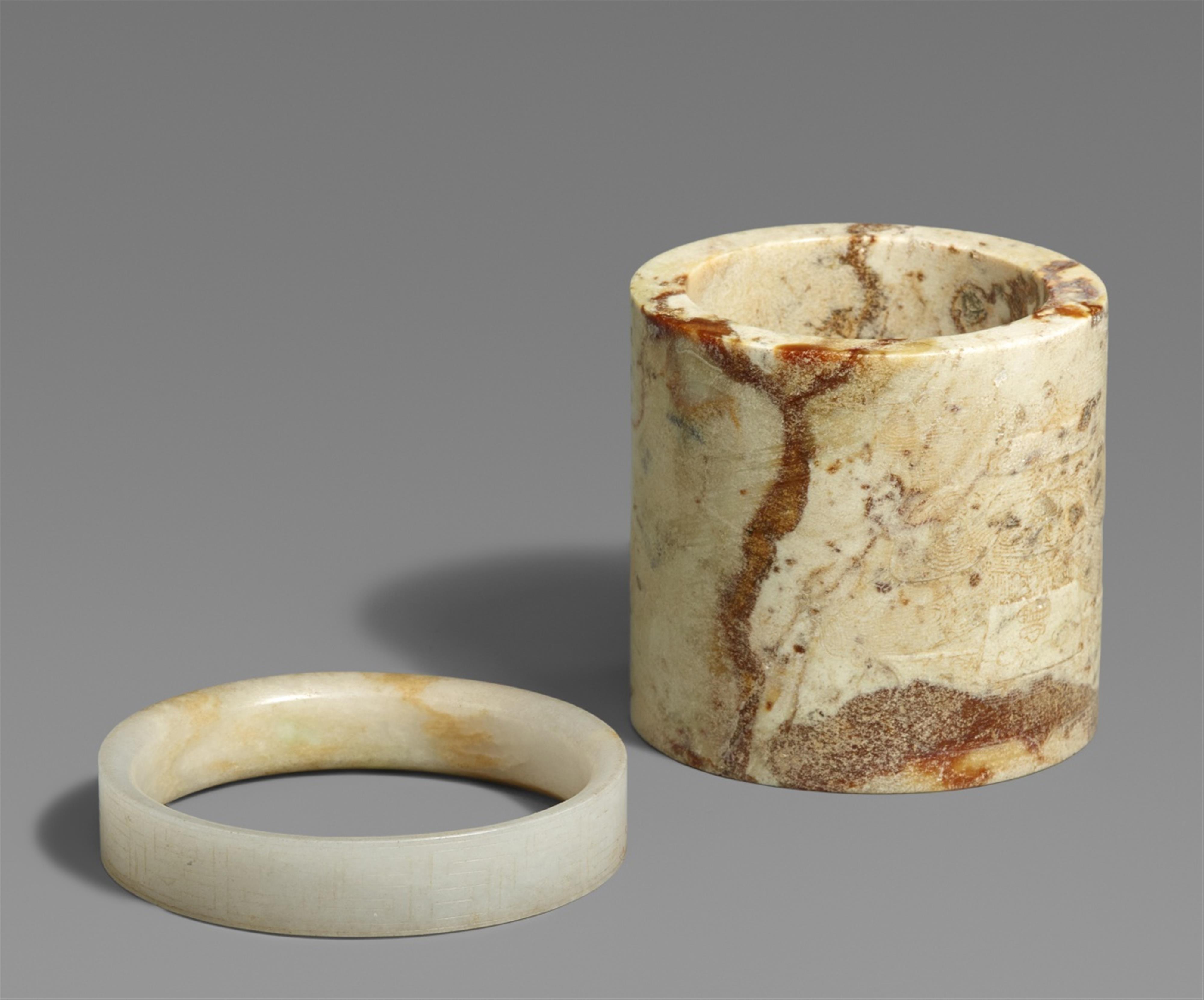 A jade ring and a stone cylinder - image-1