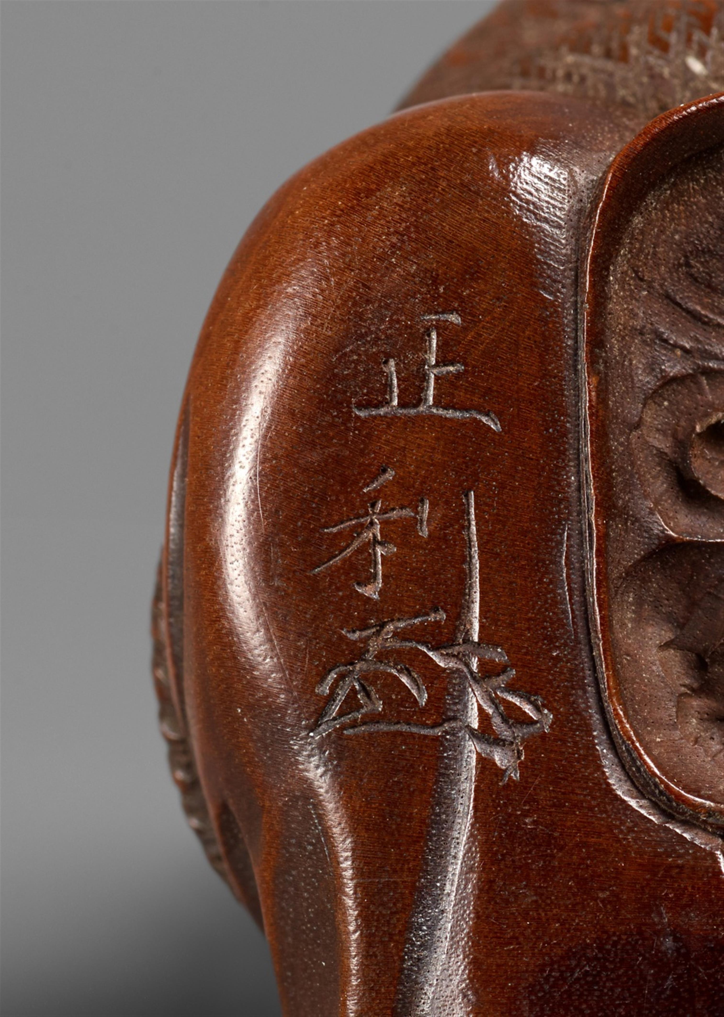 A Nagoya school fruitwood netsuke of Okame on a long-nosed mask, by Masatoshi. Mid-19th century - image-3