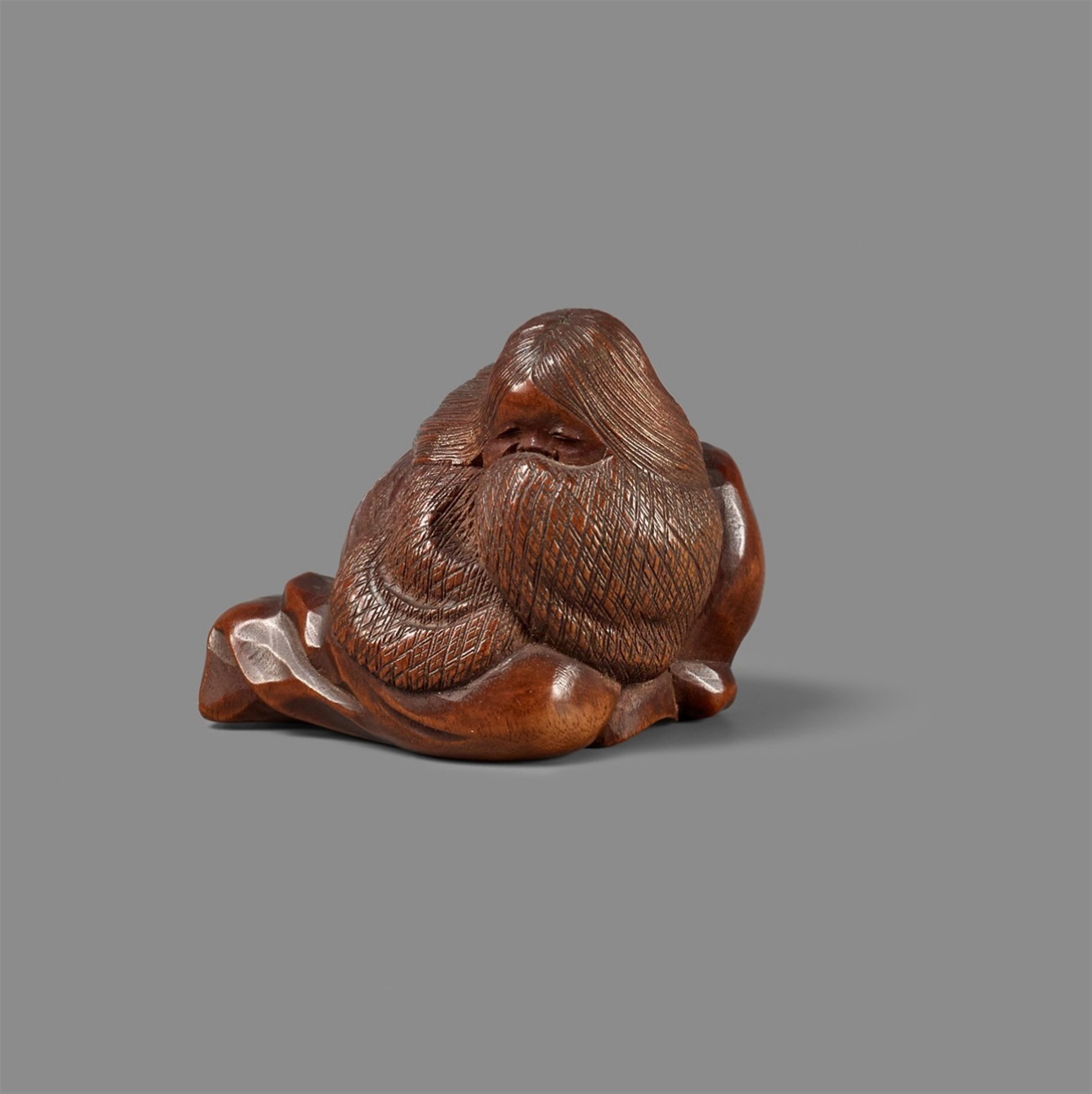 A Nagoya school fruitwood netsuke of Okame on a long-nosed mask, by Masatoshi. Mid-19th century - image-1