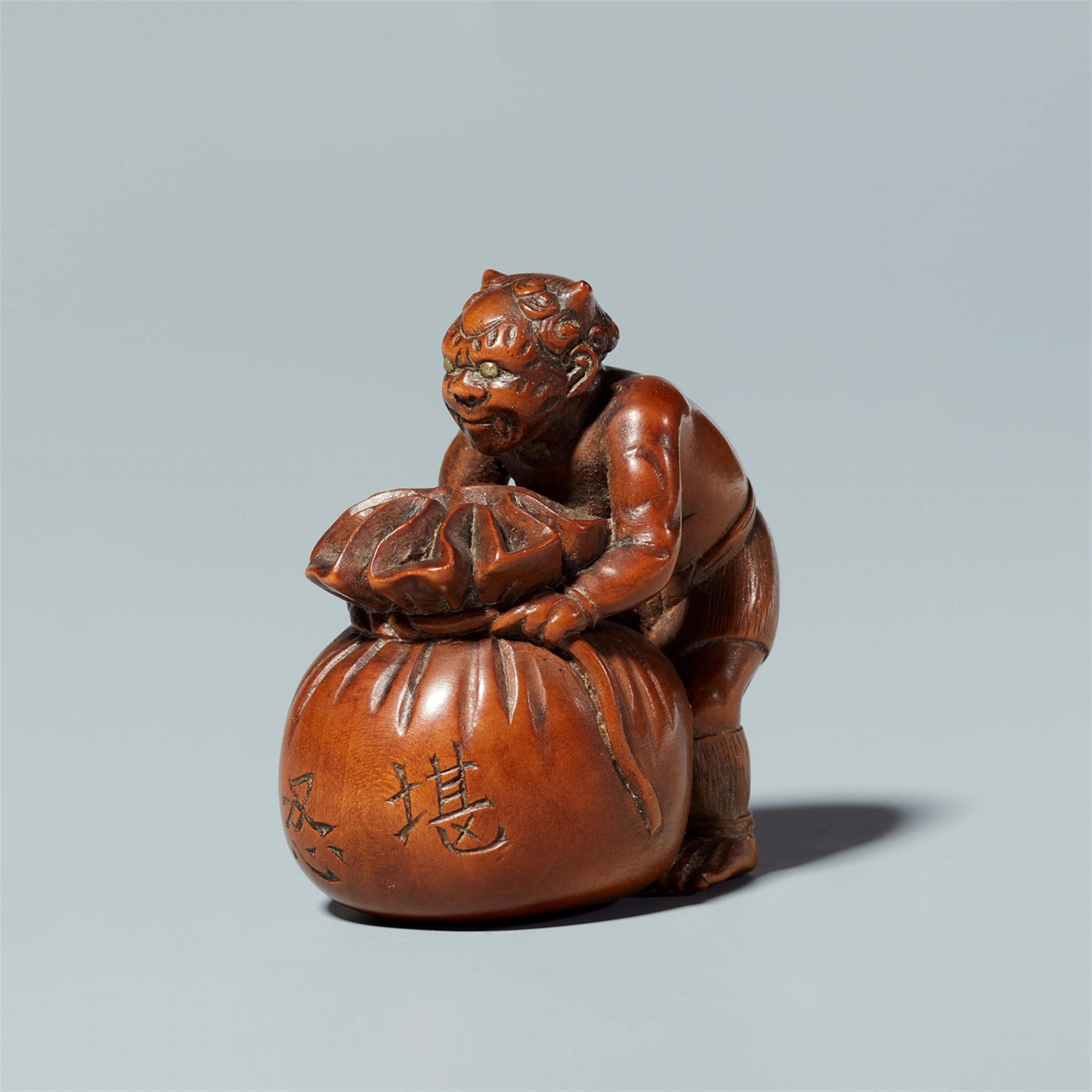 A boxwood netsuke of oni with a sack, by Minsai. Around 1830 - image-2