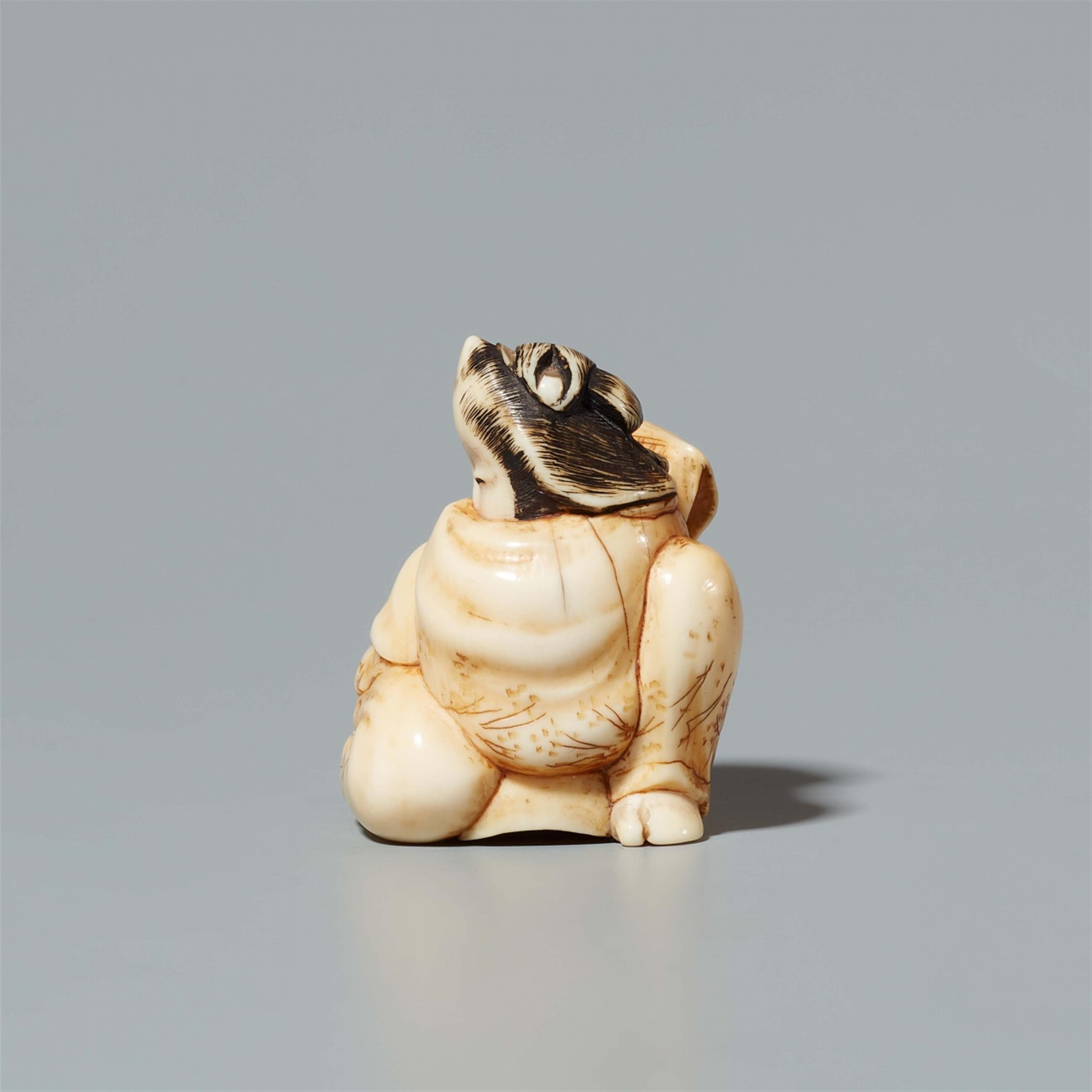 An ivory netsuke of a geisha seated on a tengu mask. 19th century - image-2