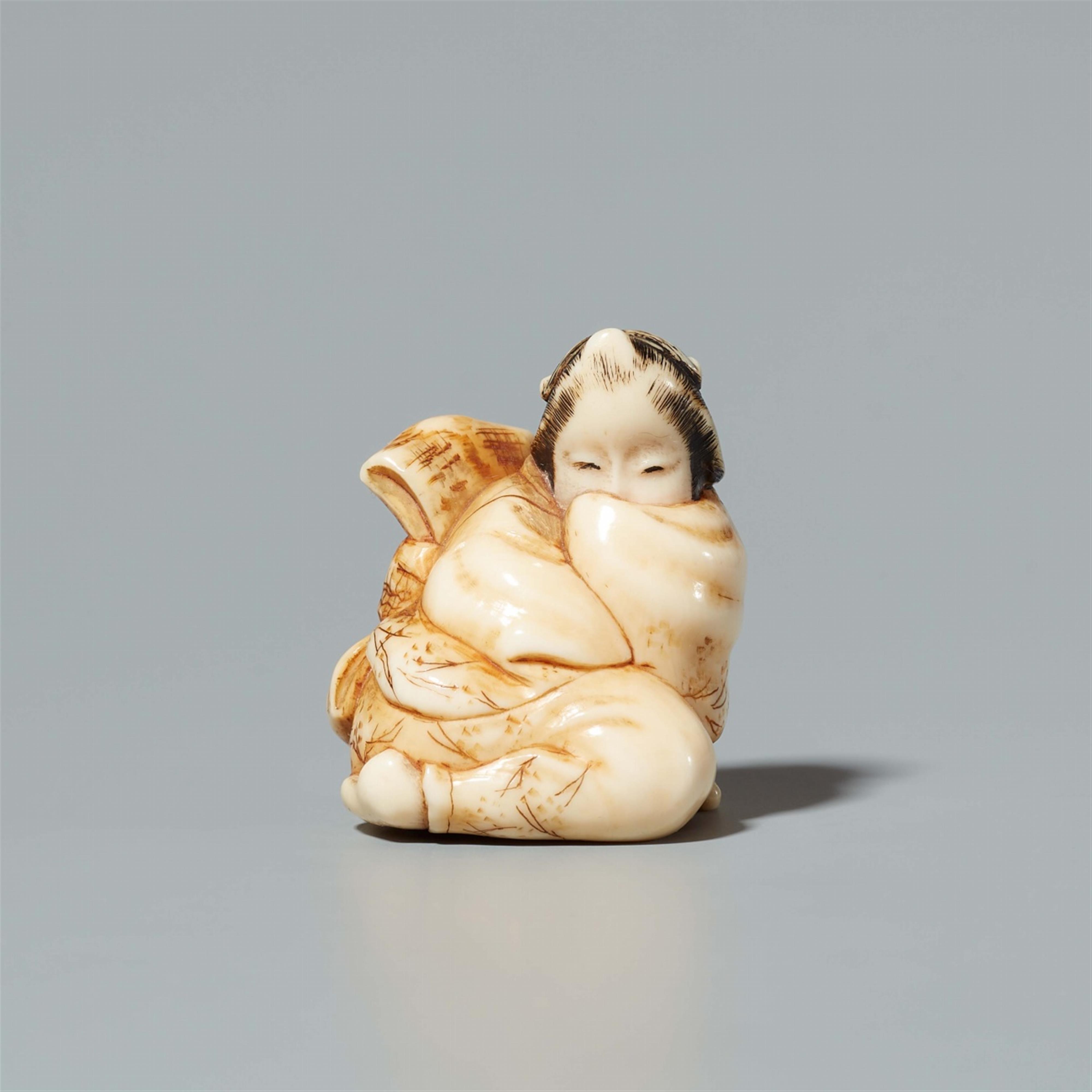 An ivory netsuke of a geisha seated on a tengu mask. 19th century - image-1