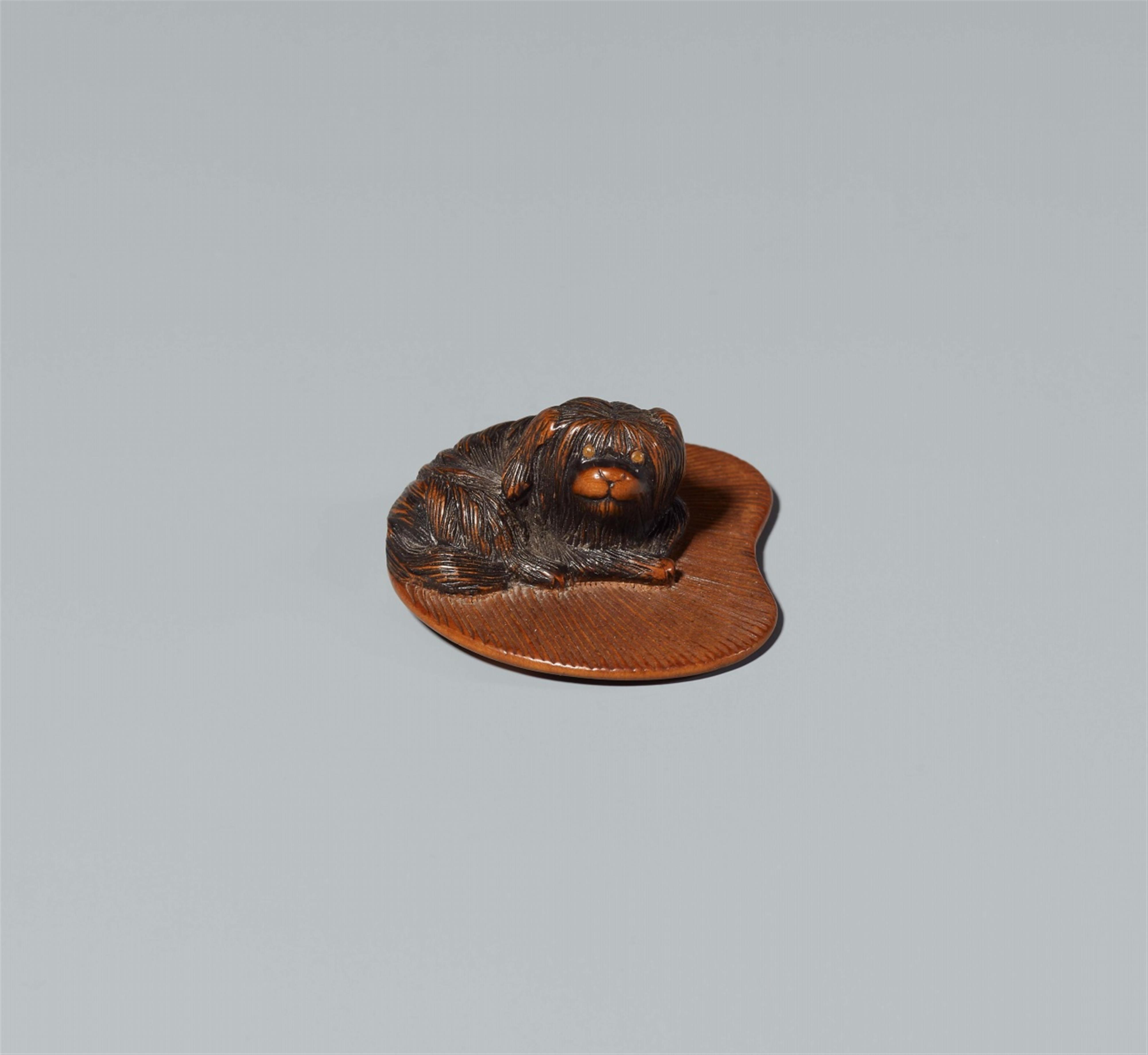 A boxwood netsuke of a small dog and a fan. Early 19th century - image-1