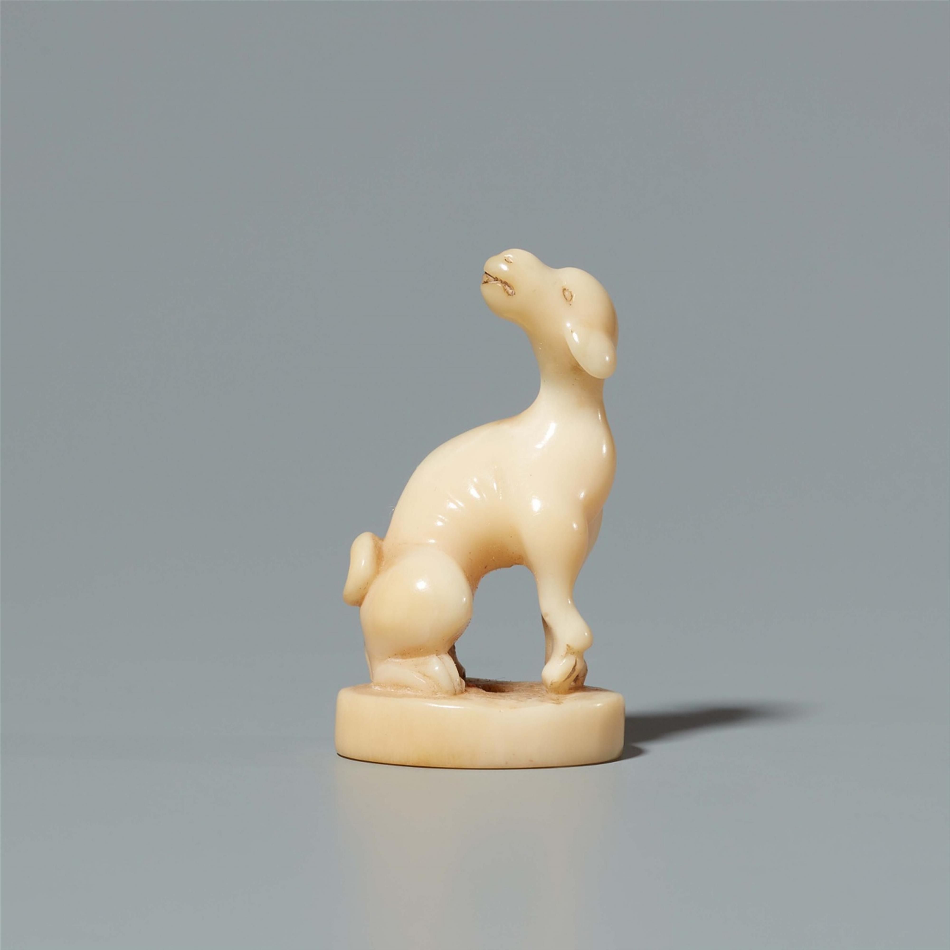 A walrus tooth netsuke of a dog on an oval base. Second half 19th century - image-1