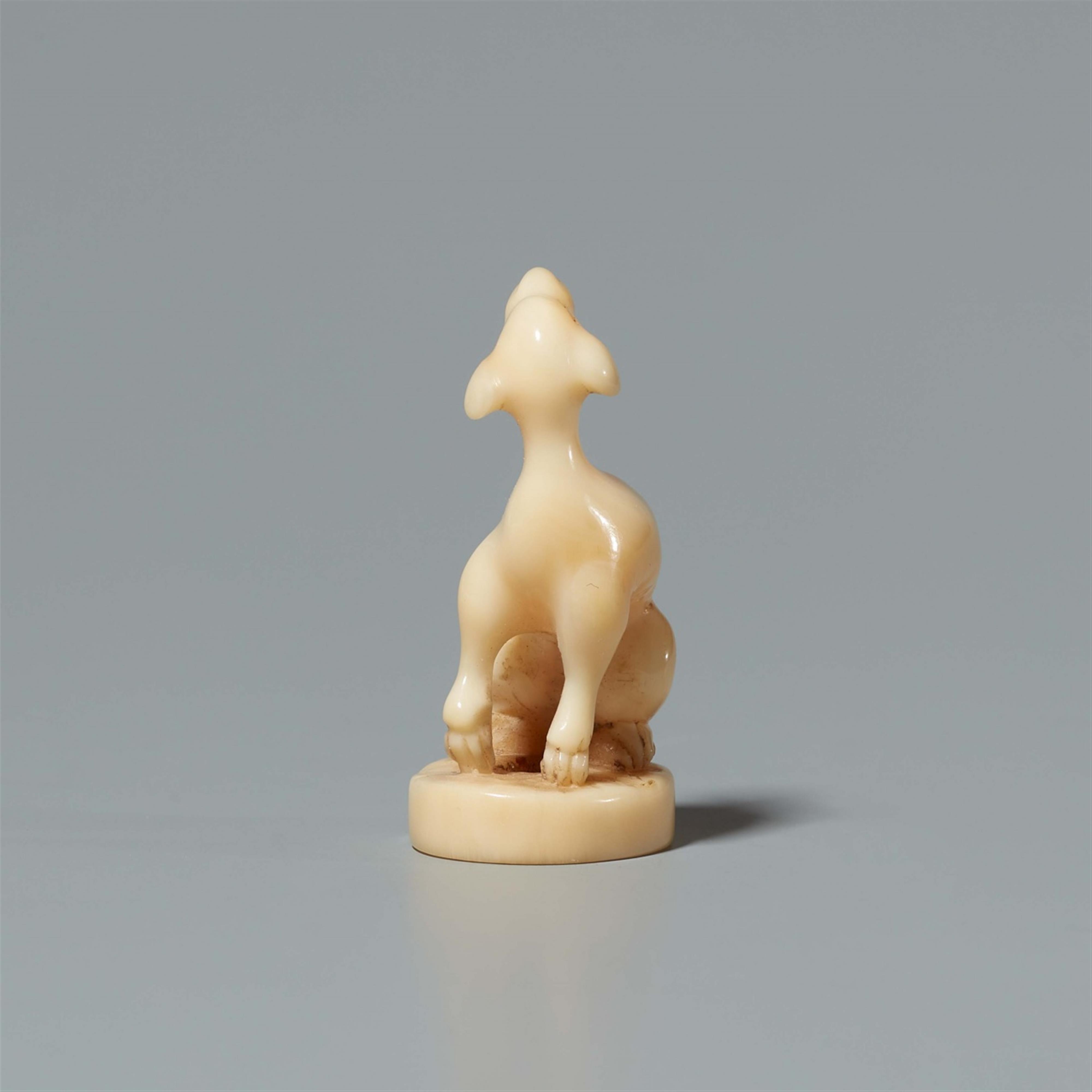 A walrus tooth netsuke of a dog on an oval base. Second half 19th century - image-2