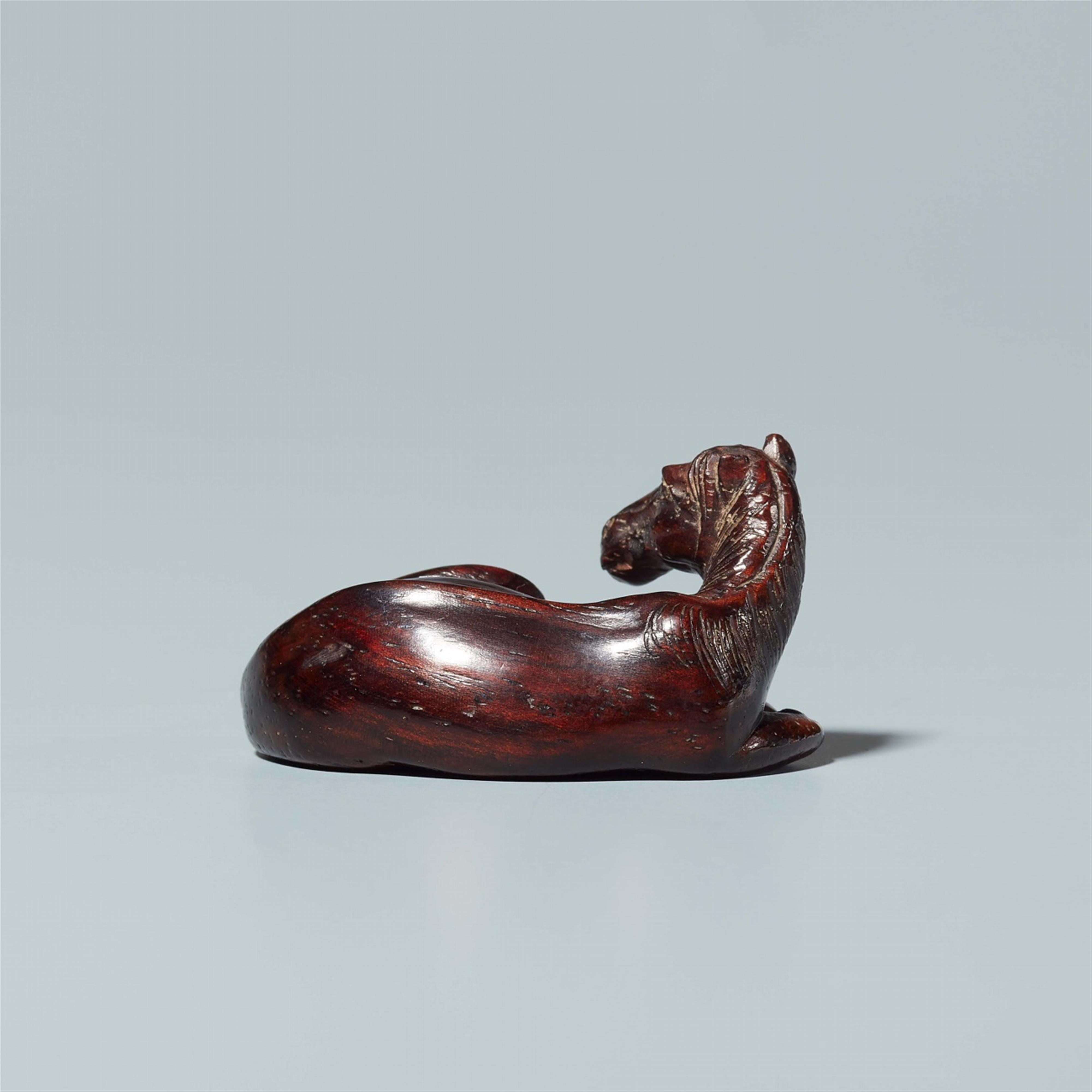 A tagayasan wood netsuke of a reclining horse. Probably last third 19th century - image-2