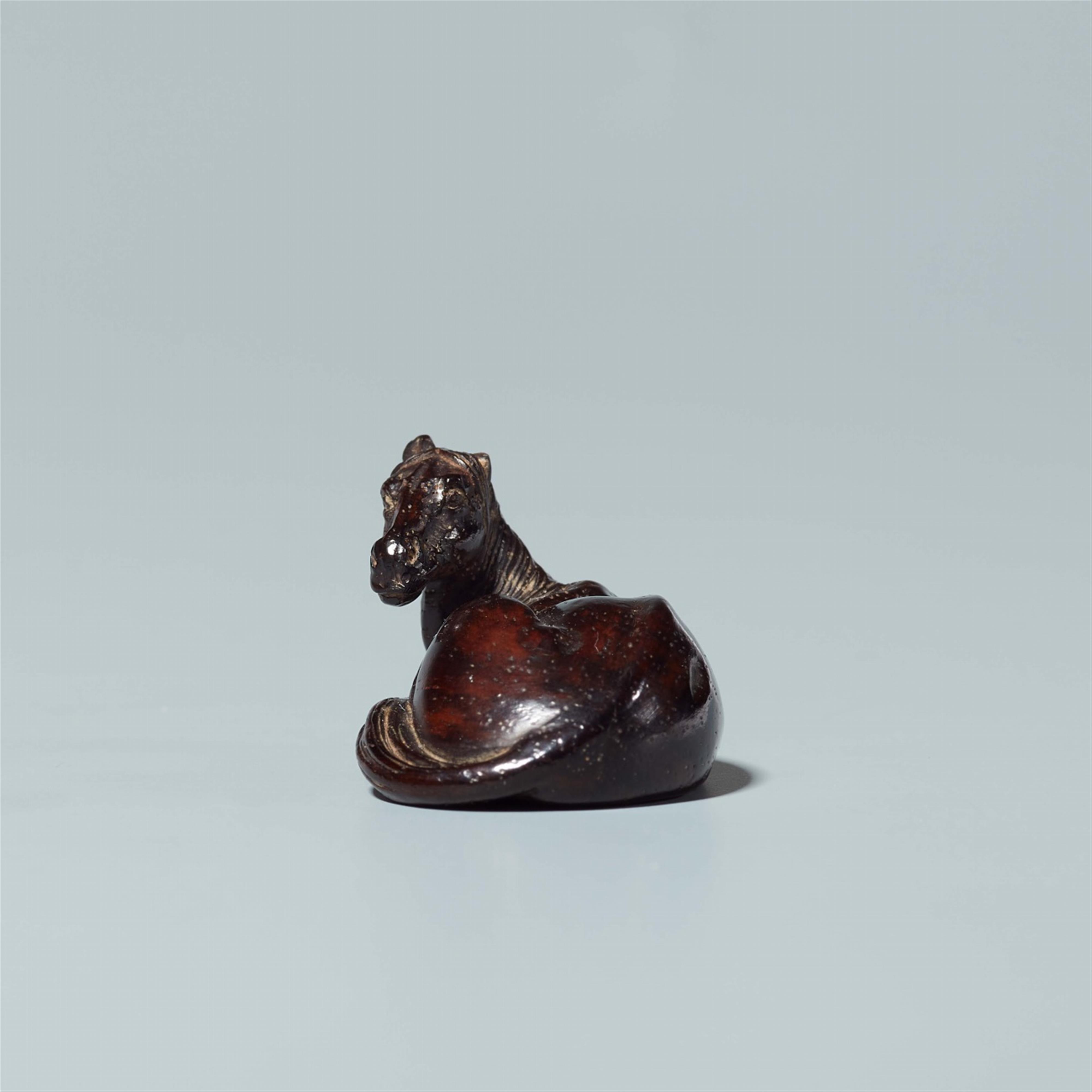 A tagayasan wood netsuke of a reclining horse. Probably last third 19th century - image-3