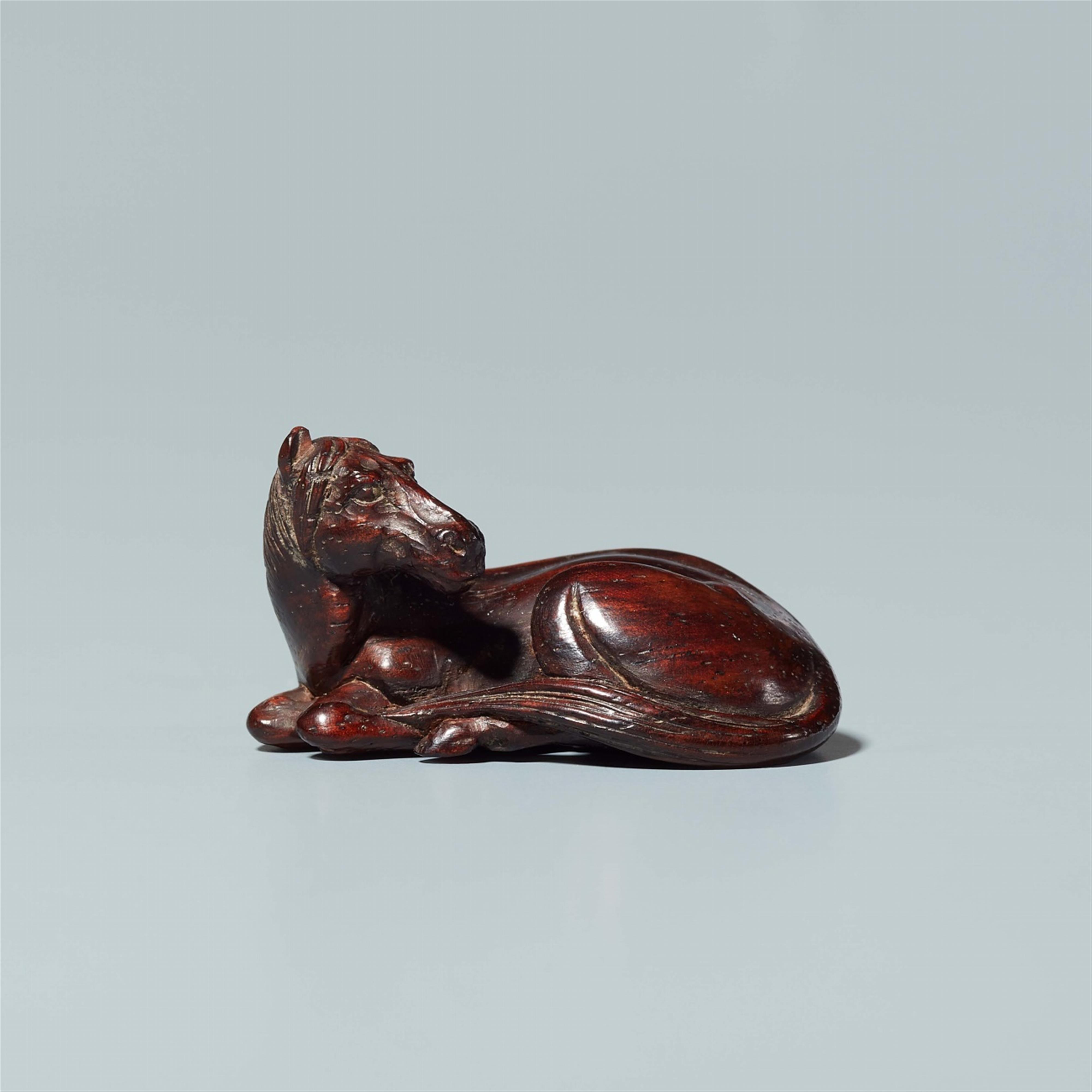 A tagayasan wood netsuke of a reclining horse. Probably last third 19th century - image-1