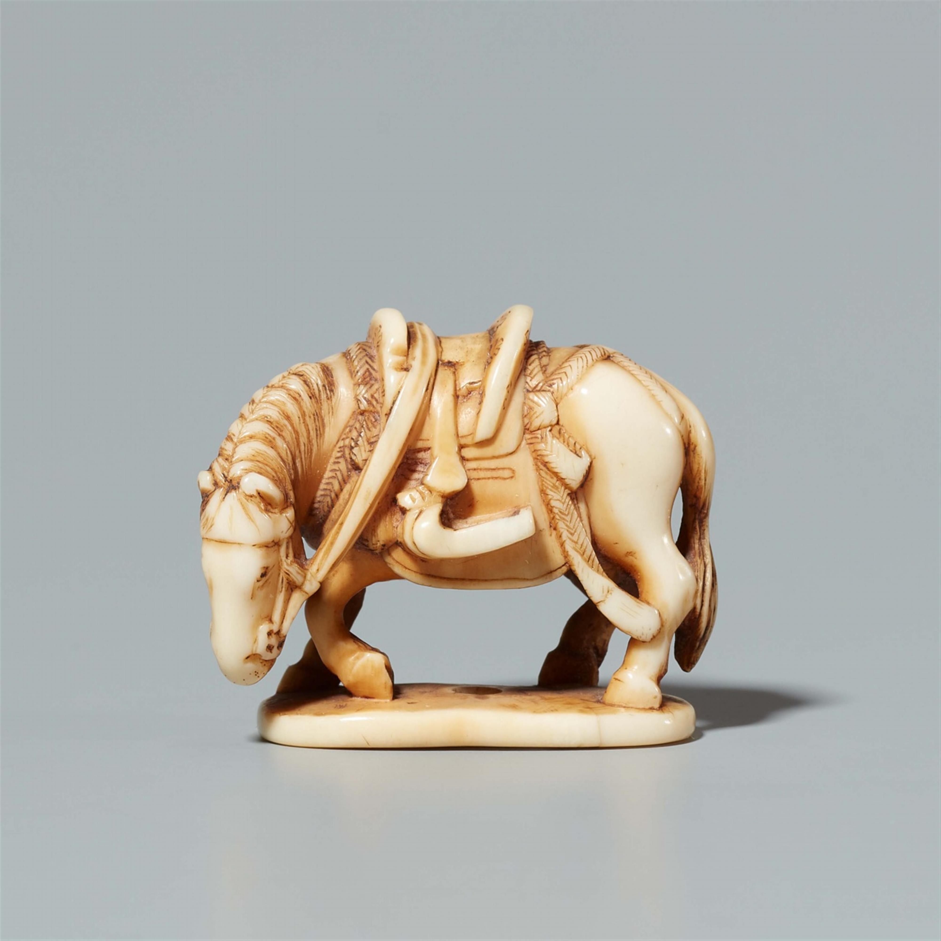 An ivory netsuke of a horse on an oval base. Late 19th century - image-1