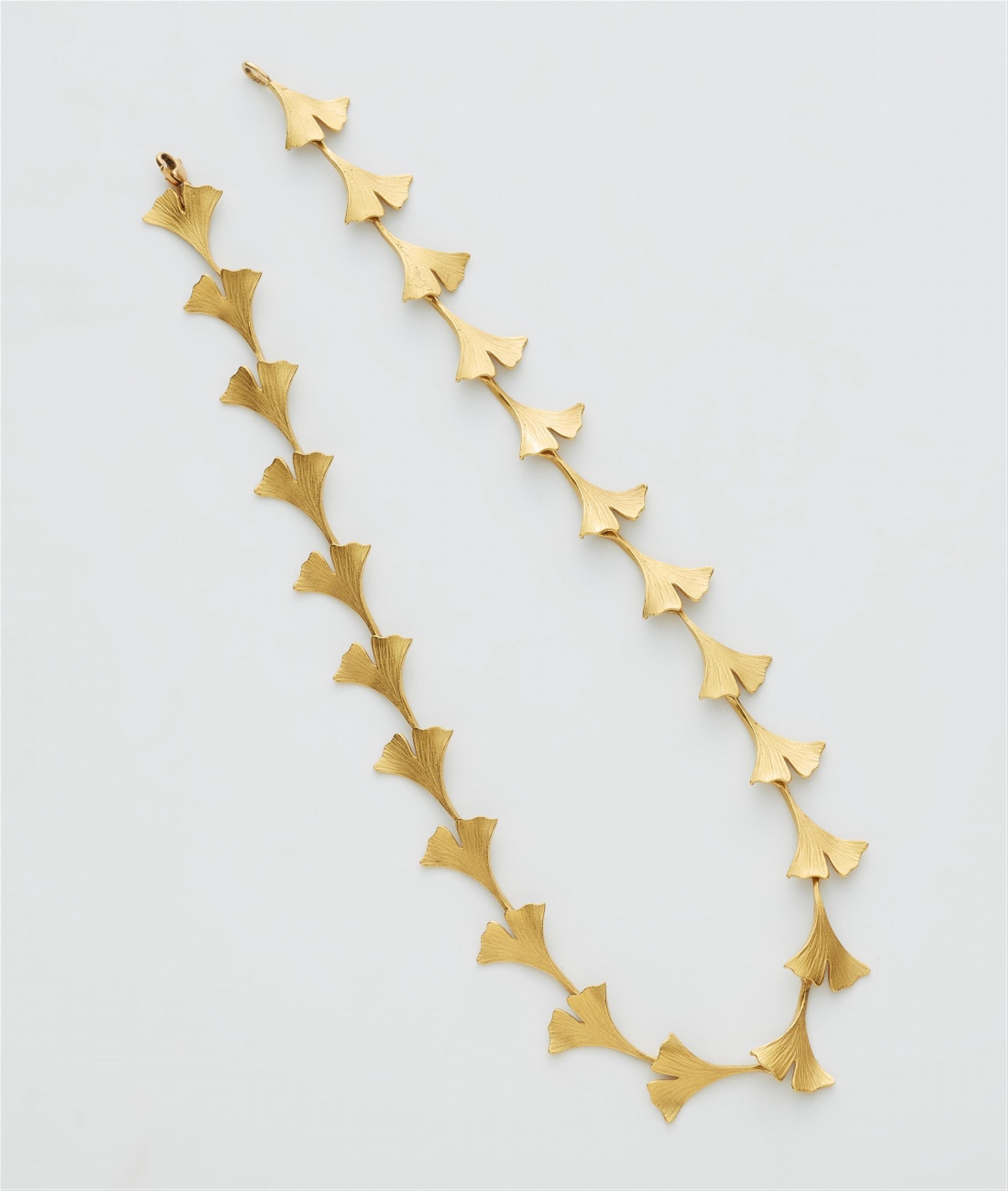 A gold gingko necklace - image-1