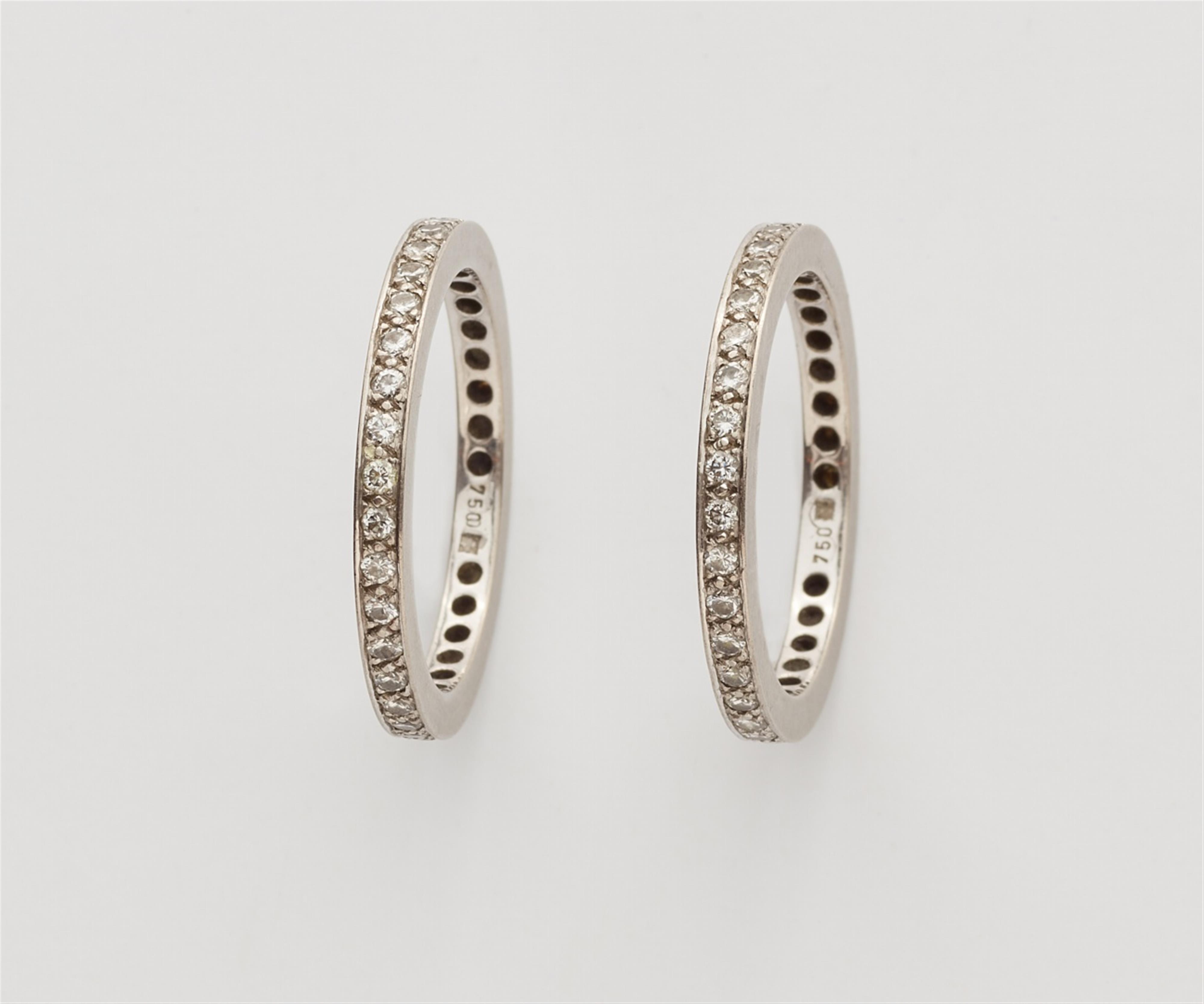 A pair of 18k white gold gentlemen's eternity rings - image-1