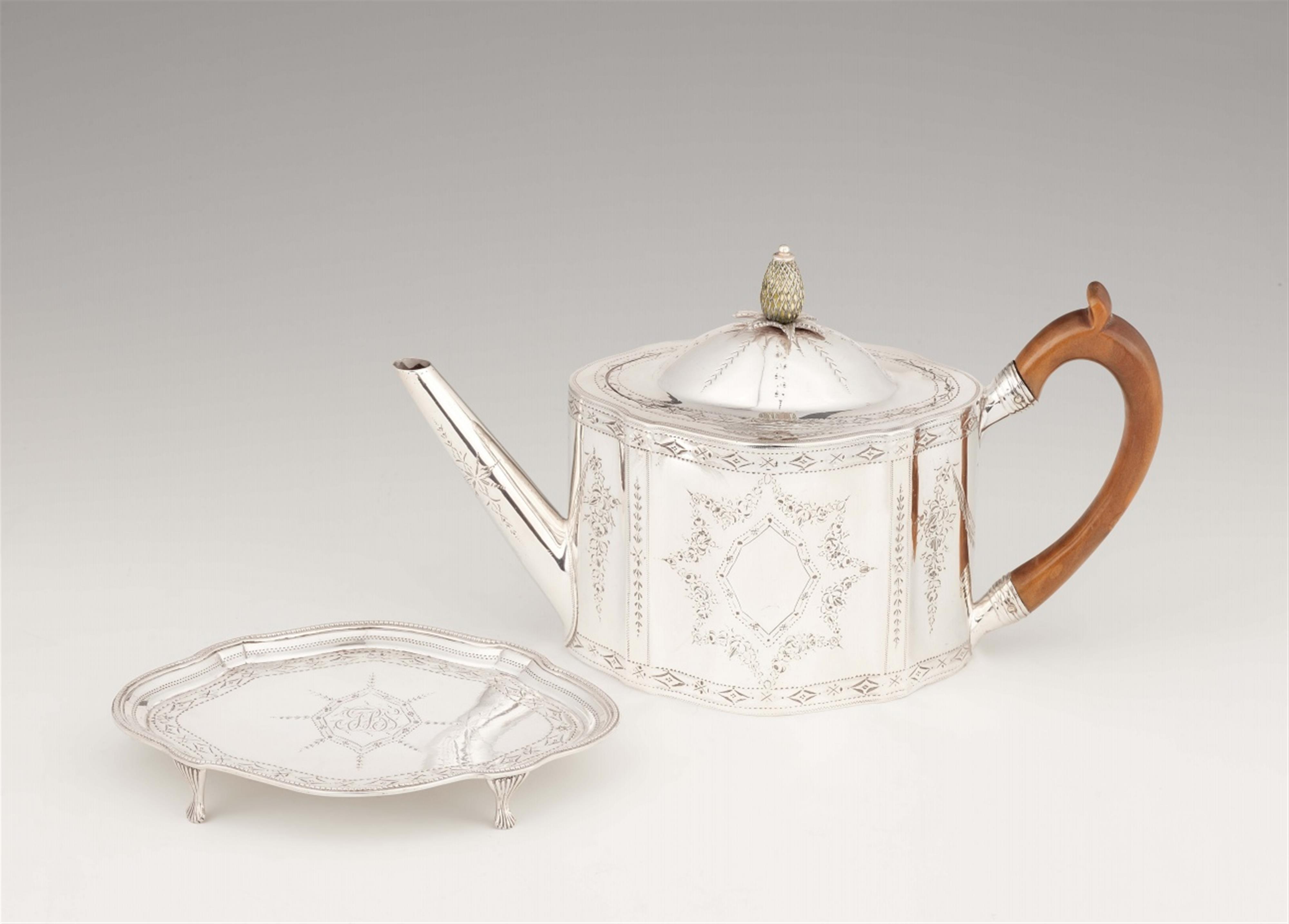 A George III silver teapot and stand - image-1