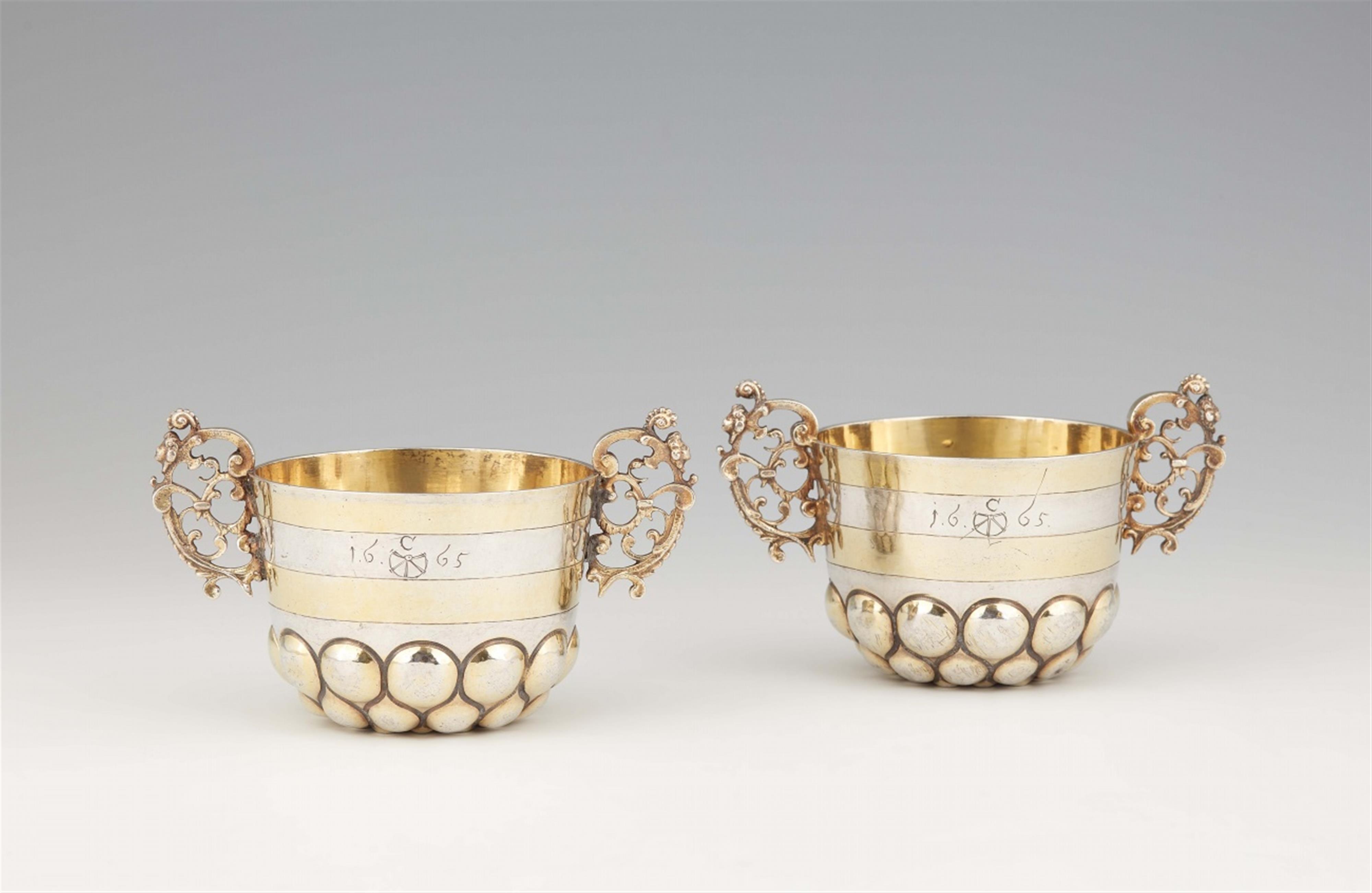 A pair of parcel gilt Kremnitz silver beakers - image-1