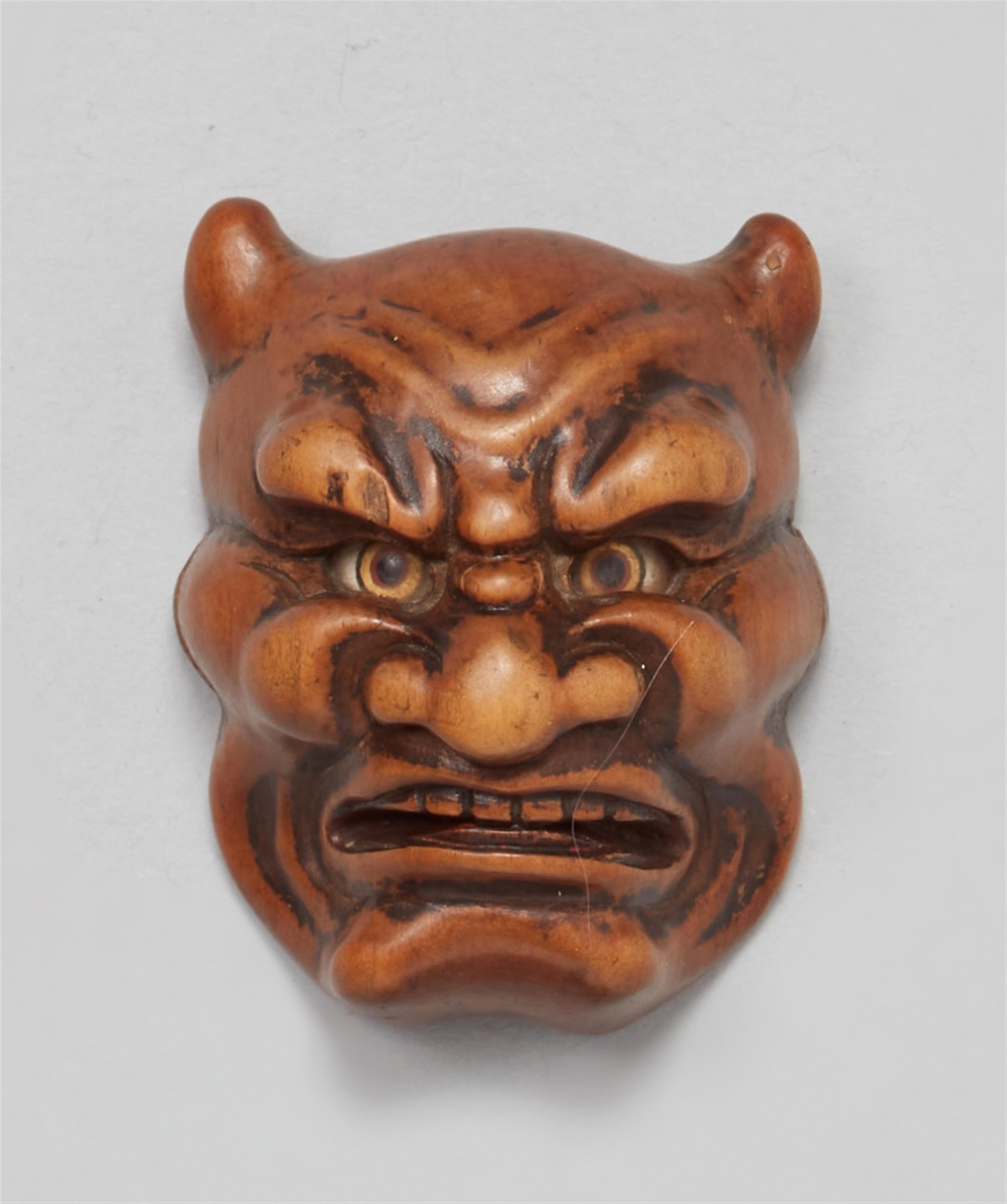 A wood netsuke of an Oni mask. 19th century - image-1