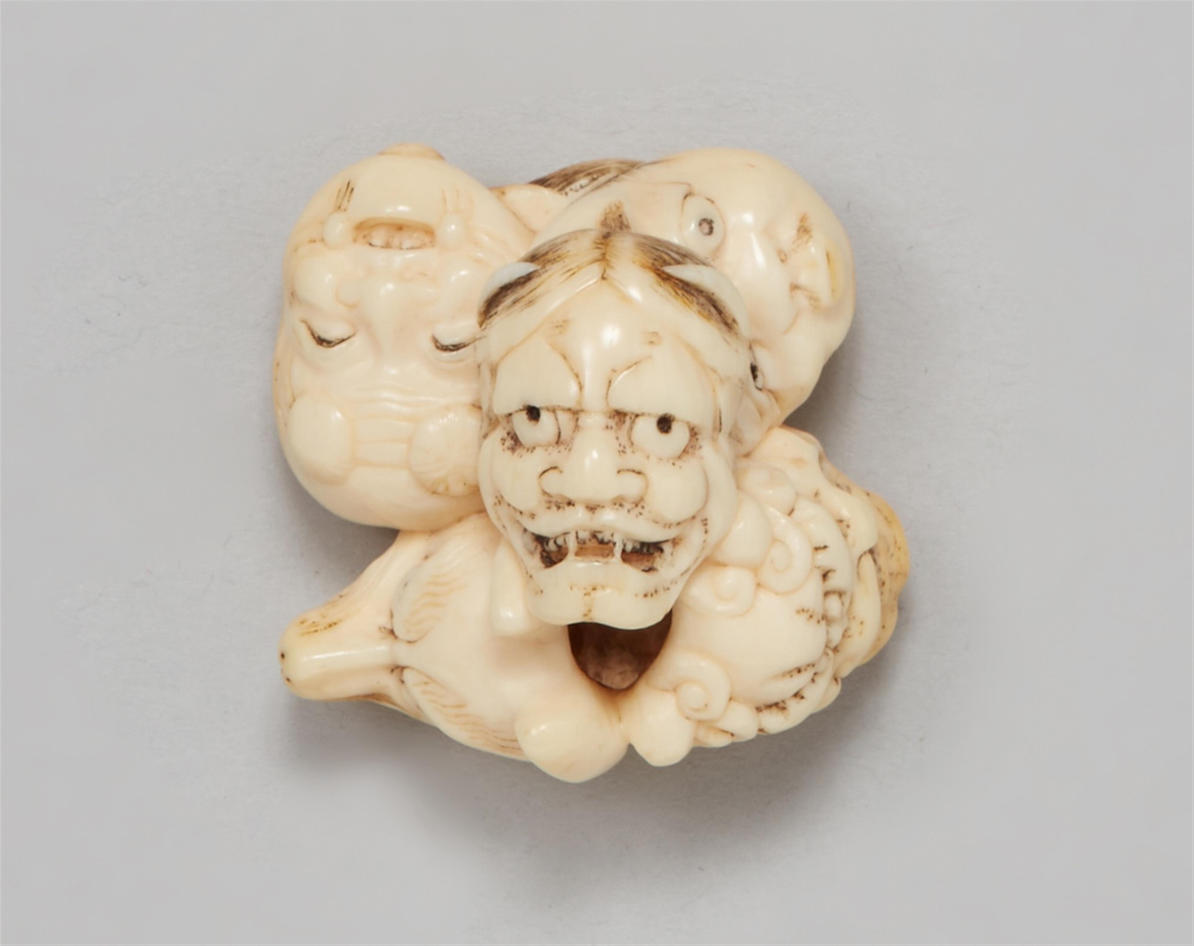 An ivory netsuke of a group of masks. Mid-19th century - image-1