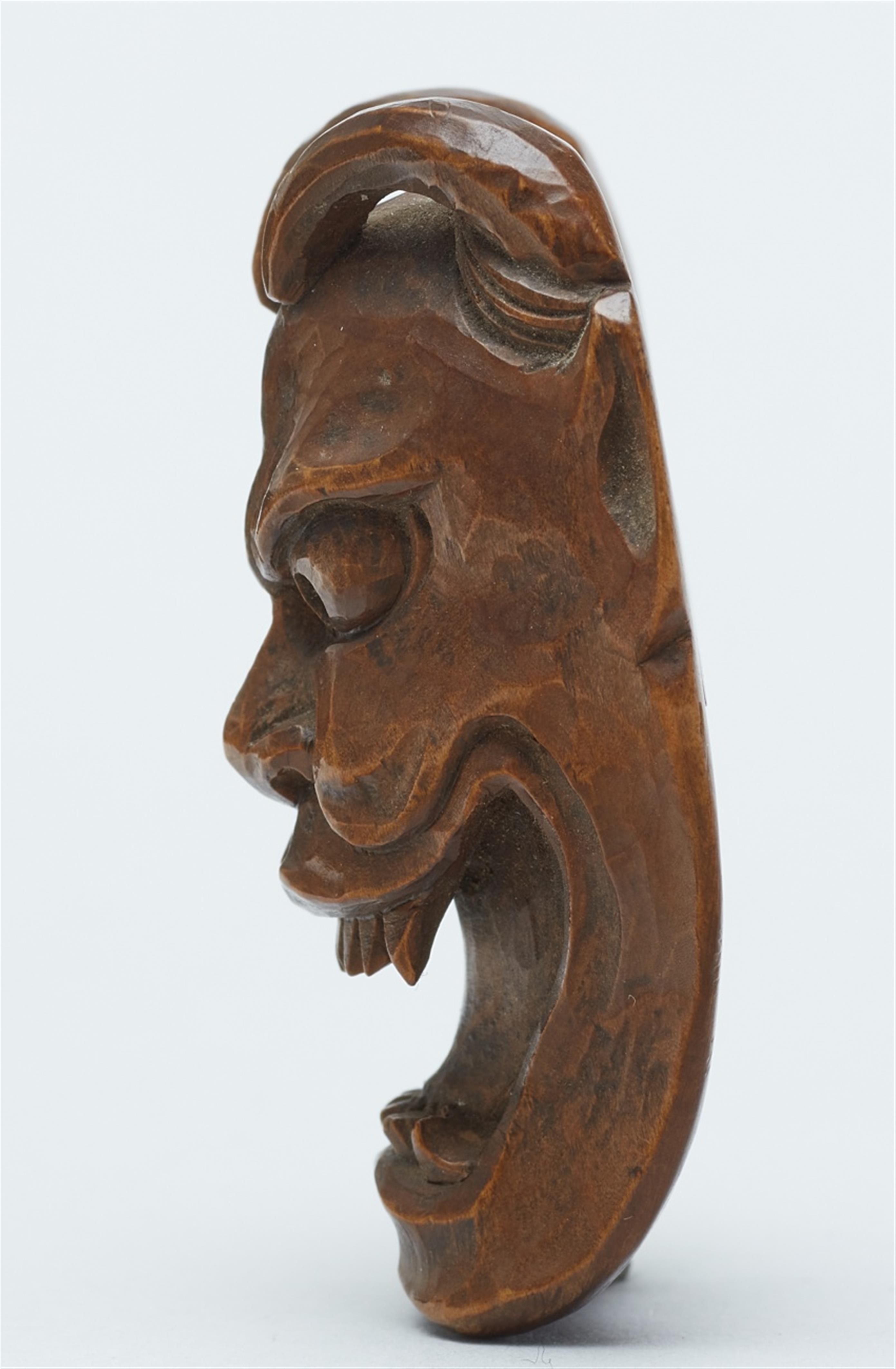 A wood netsuke of a demon mask. Late 19th century - image-4