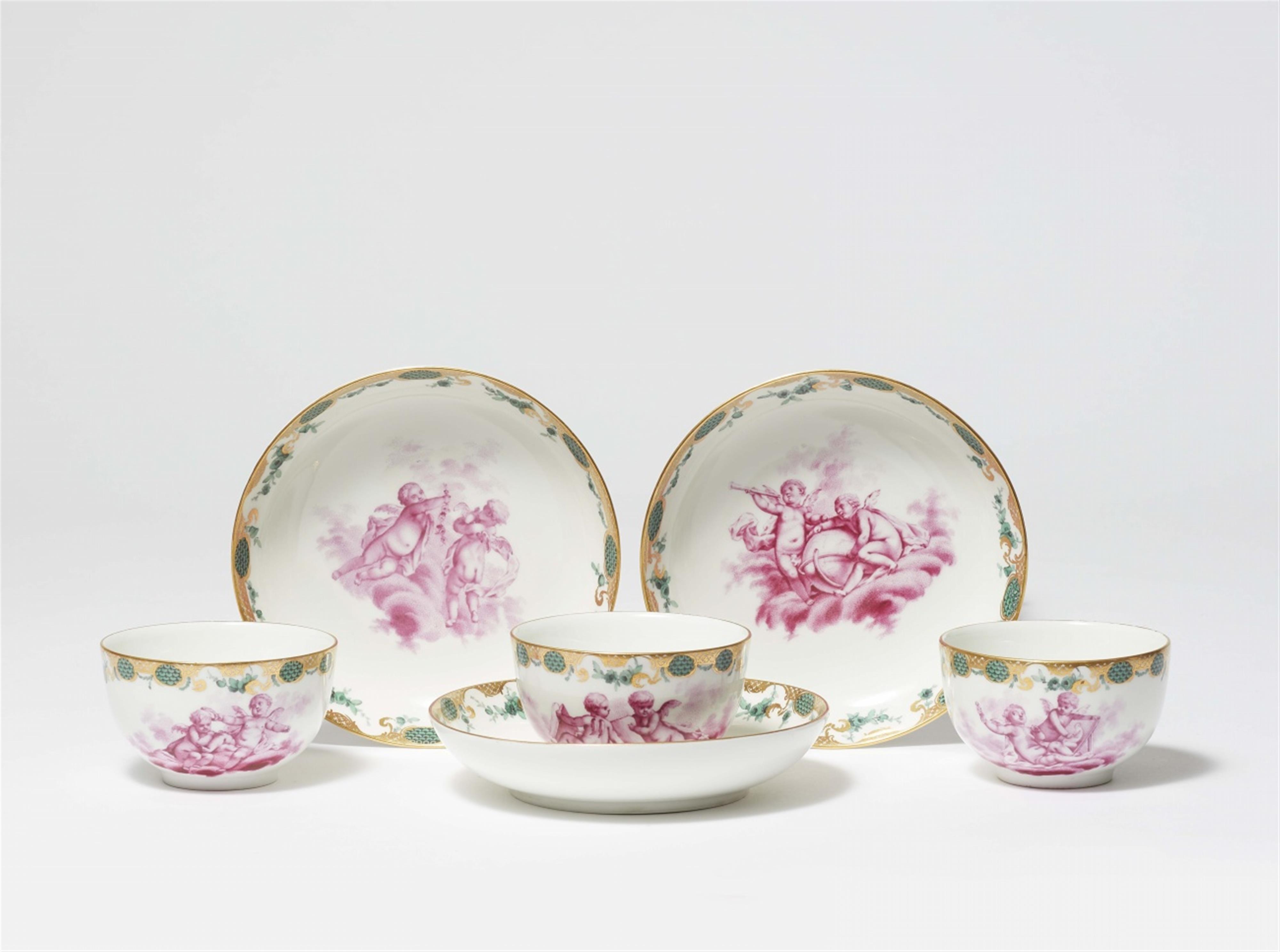 Three Berlin KPM porcelain cups and saucers with amoretti - image-1