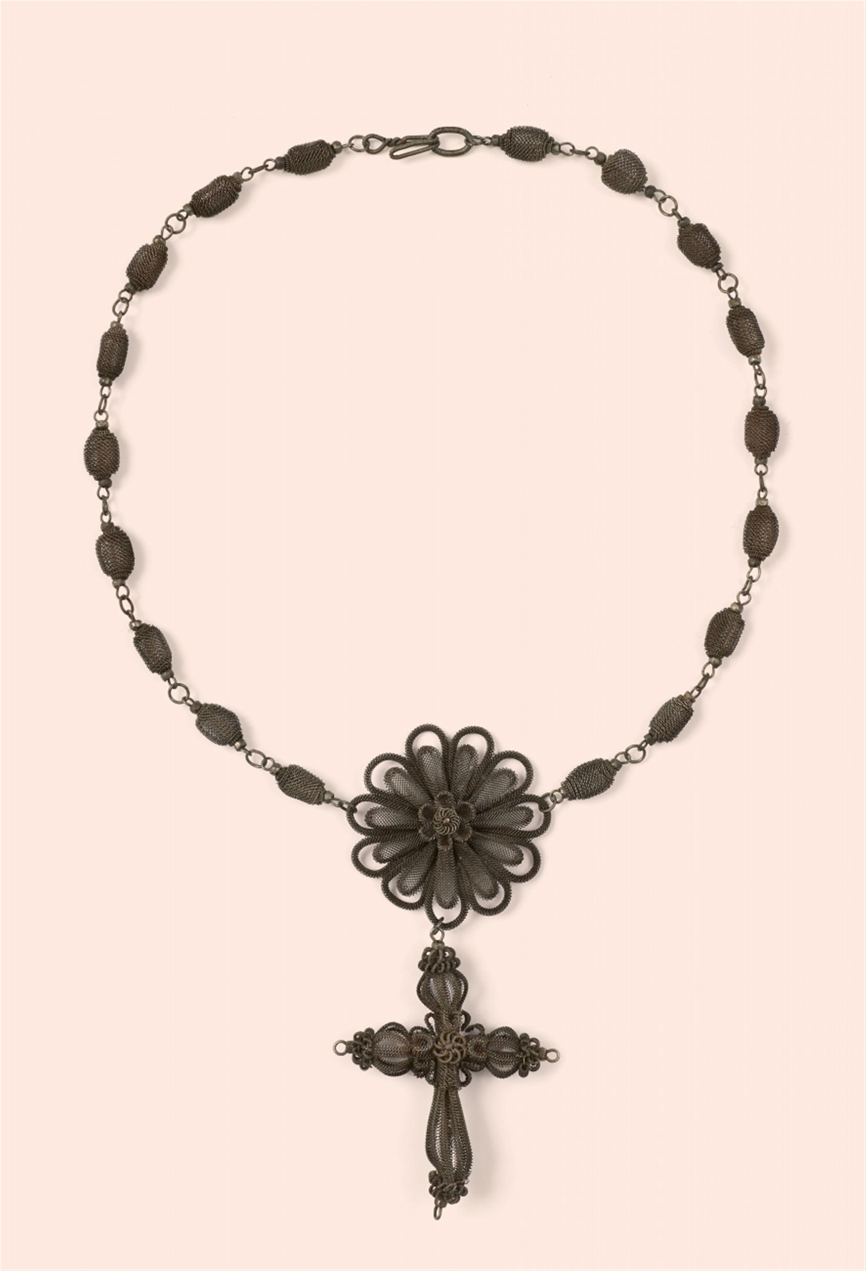 An iron necklace with a cross pendant - image-1