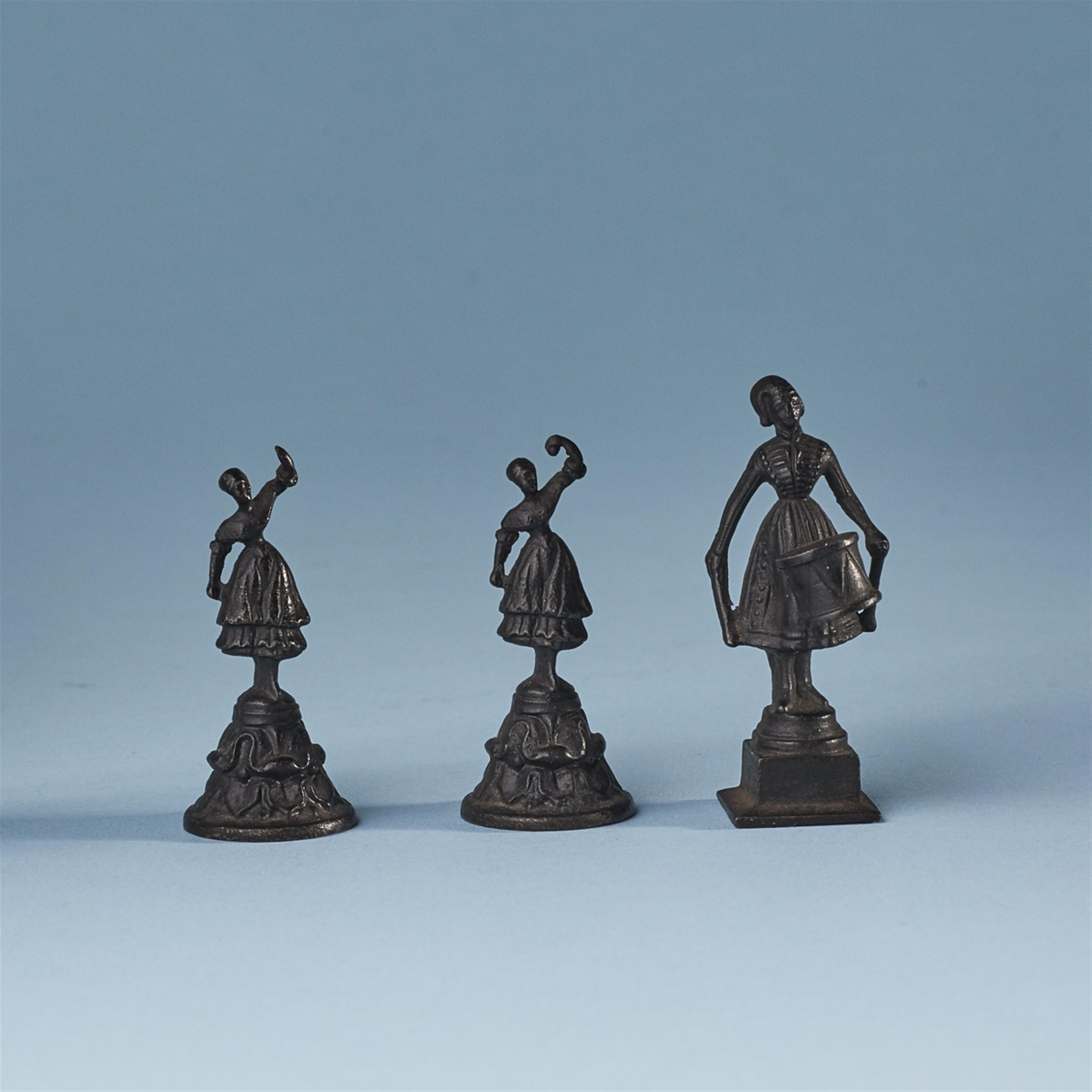 Three miniature cast iron statuettes - image-1