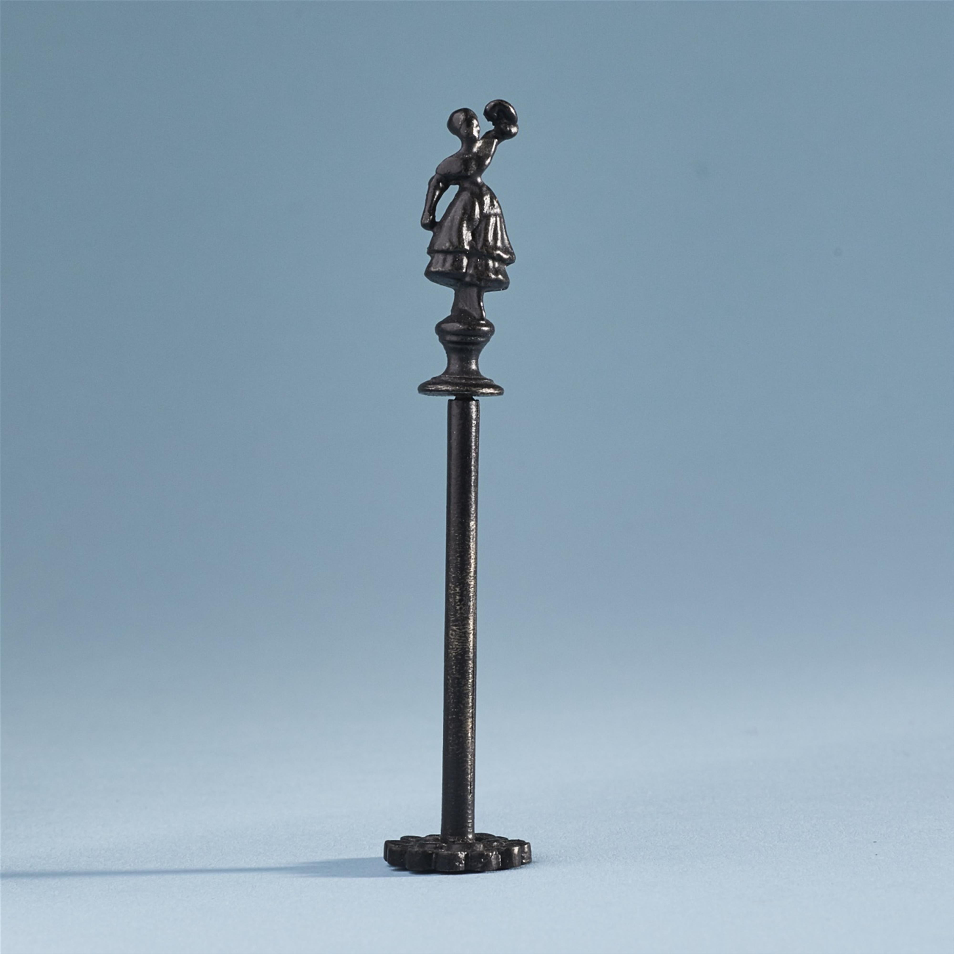 A cast iron pipe tamper with a figure of the dancer Fanny Elßler - image-1