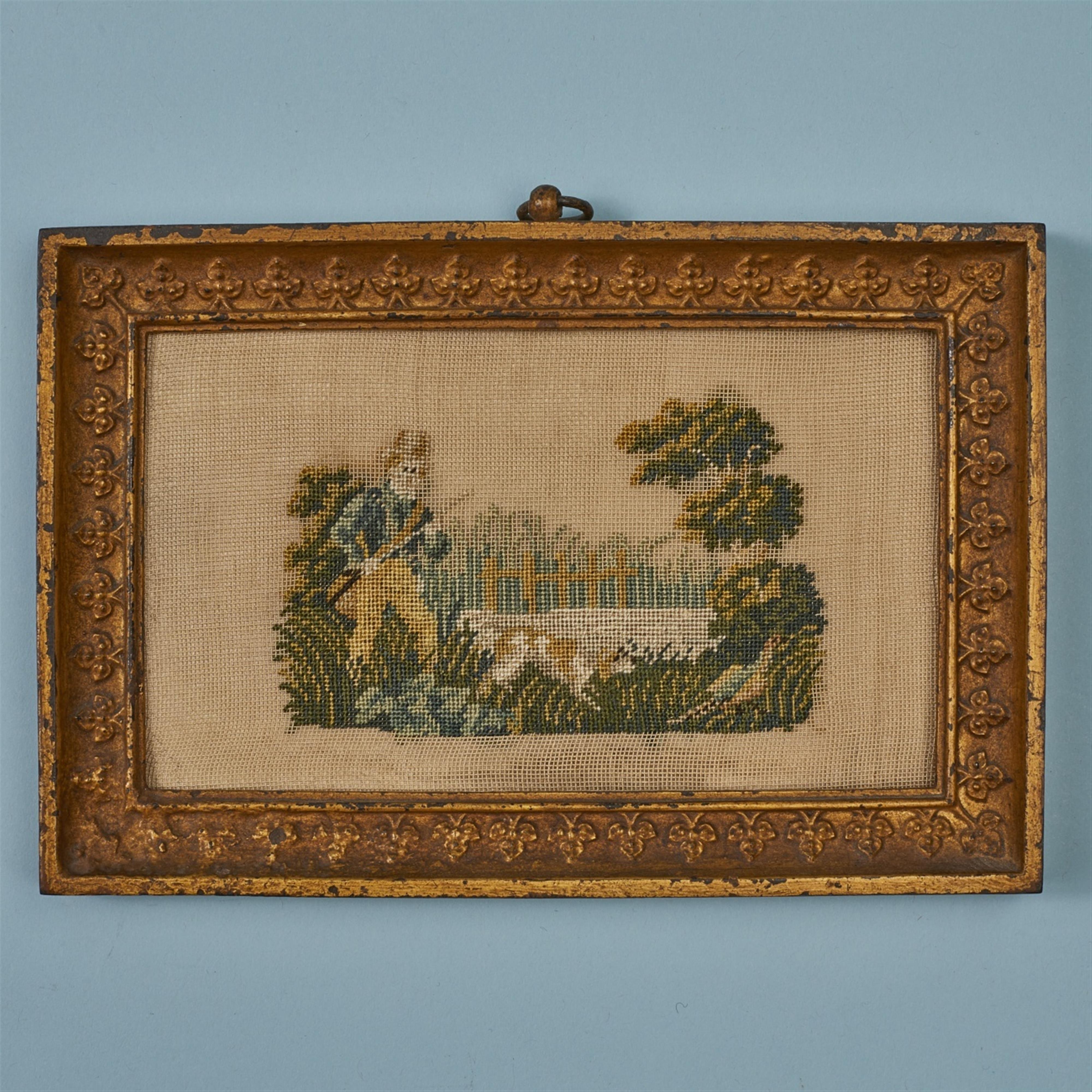 An embroidered panel in a cast iron frame - image-1