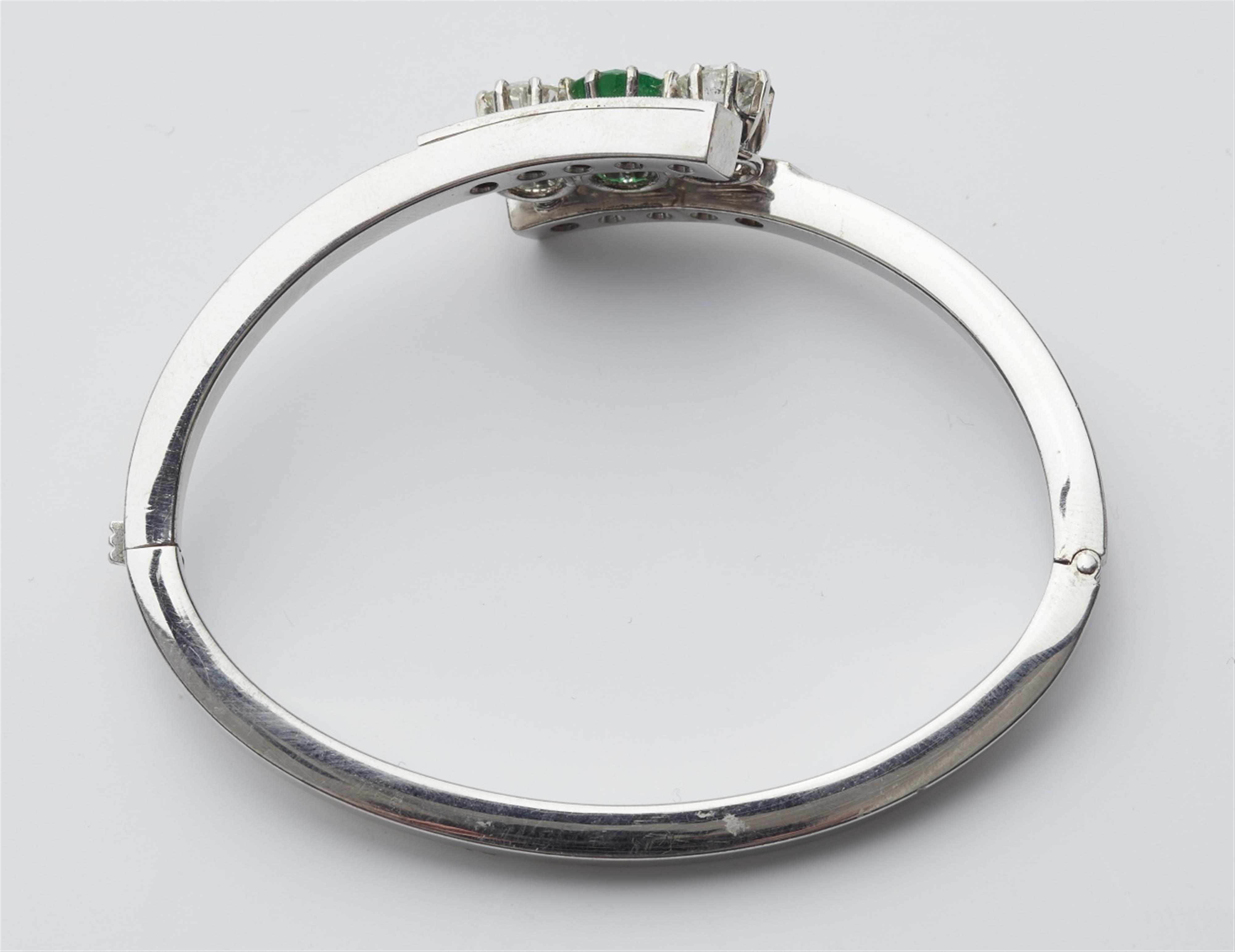 A 14k gold emerald and diamond bangle - image-3