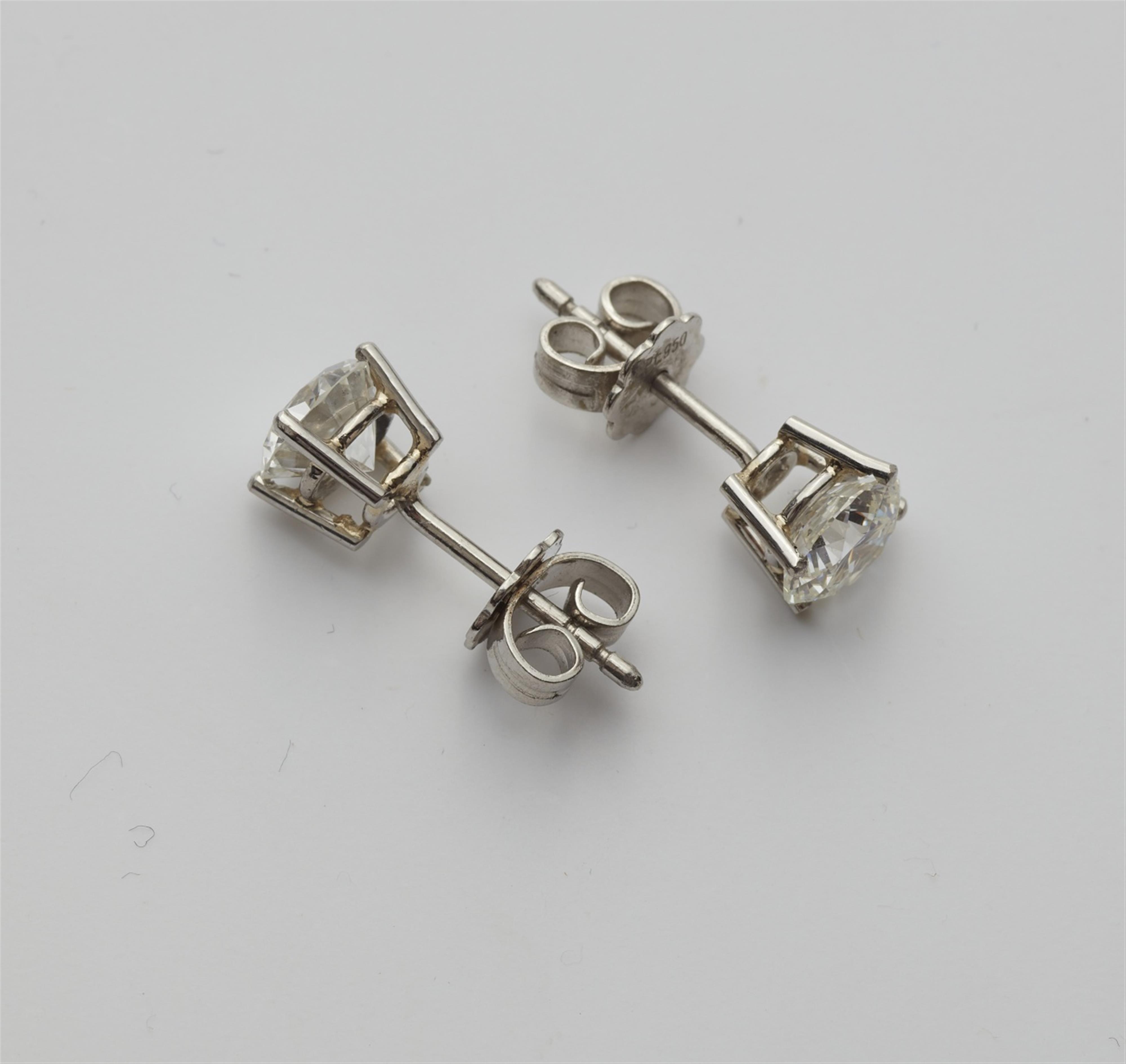 A pair of diamond solitaire earrings - image-2