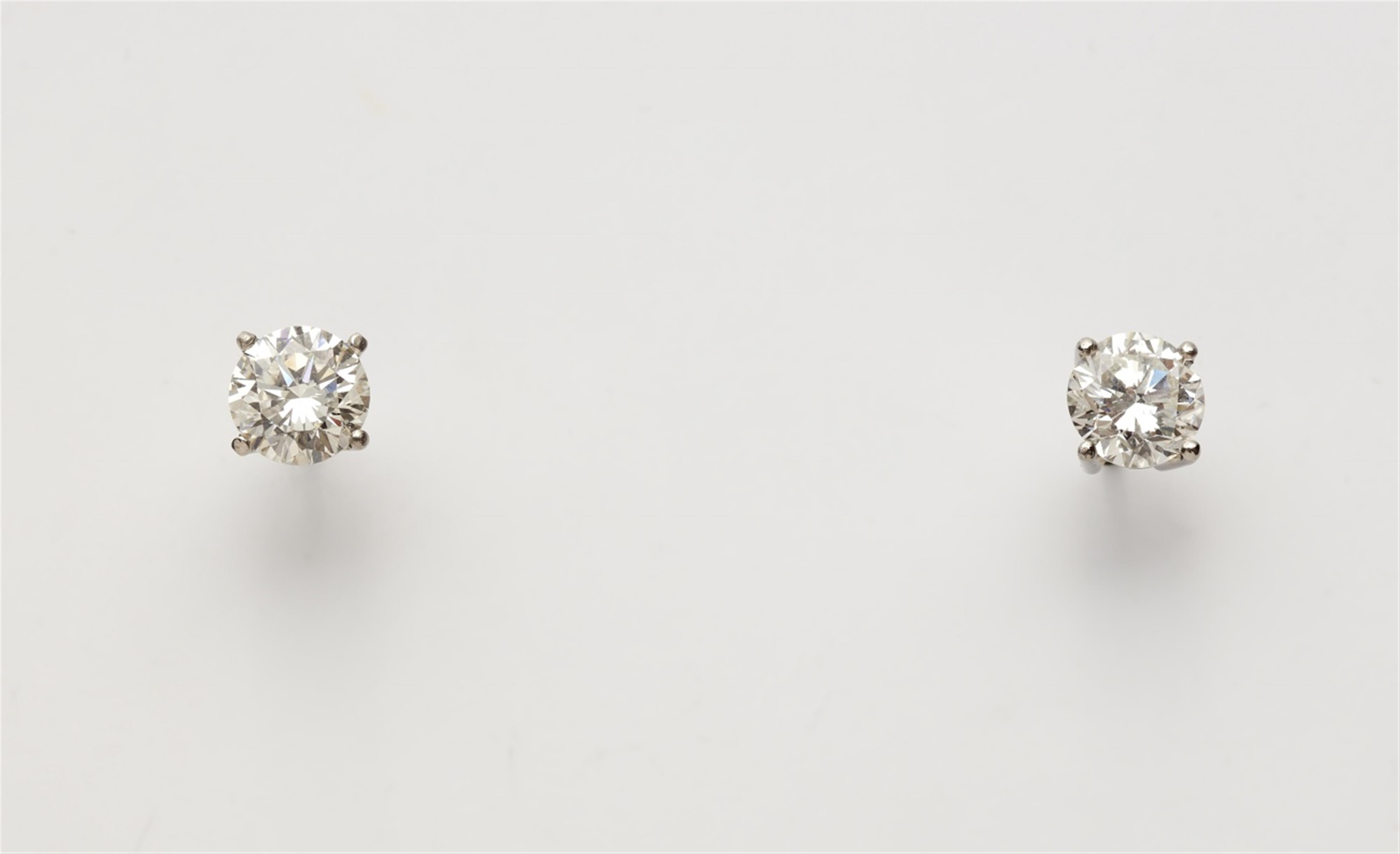A pair of diamond solitaire earrings - image-1