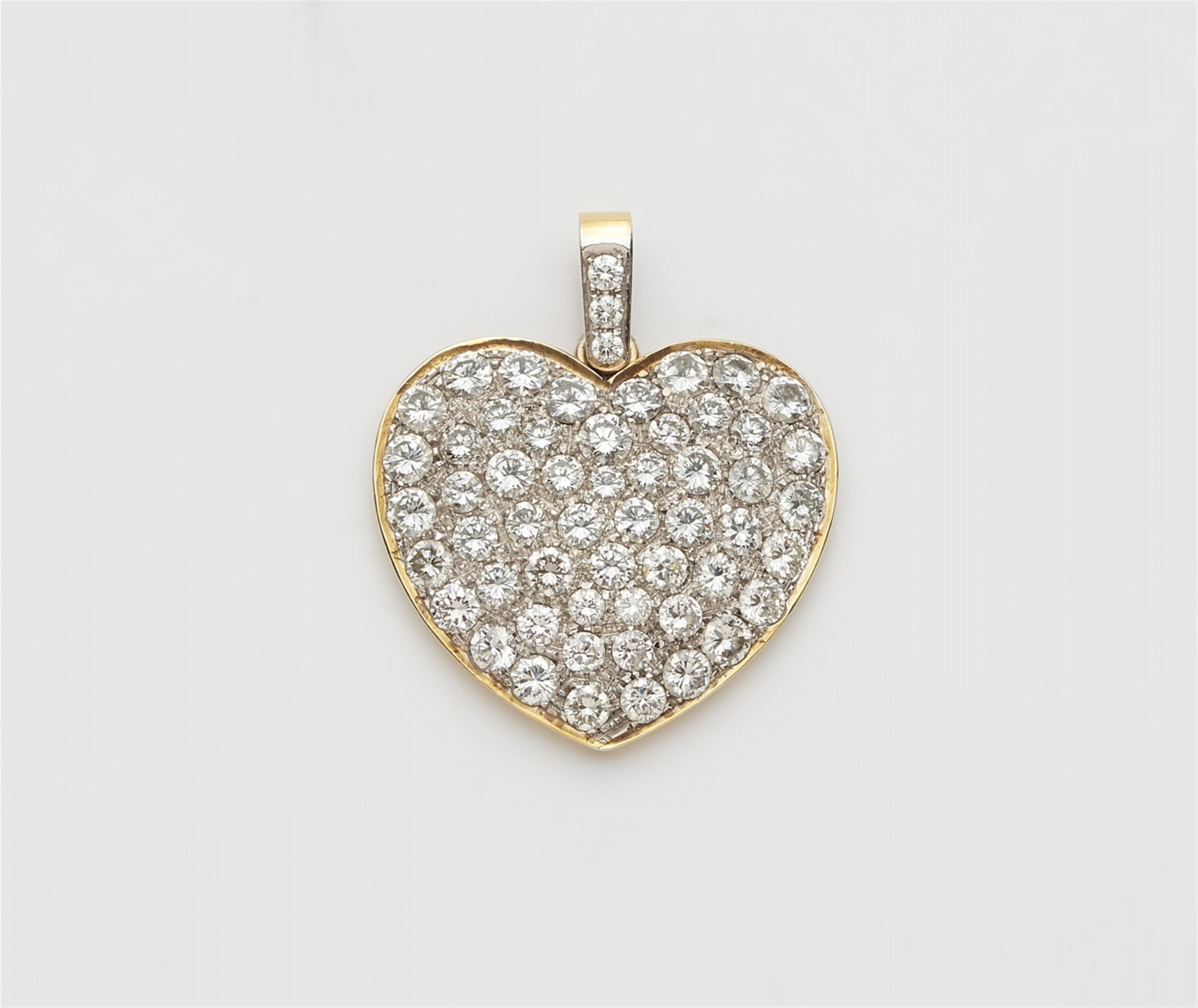 An 18k gold diamond heart pendant - image-1