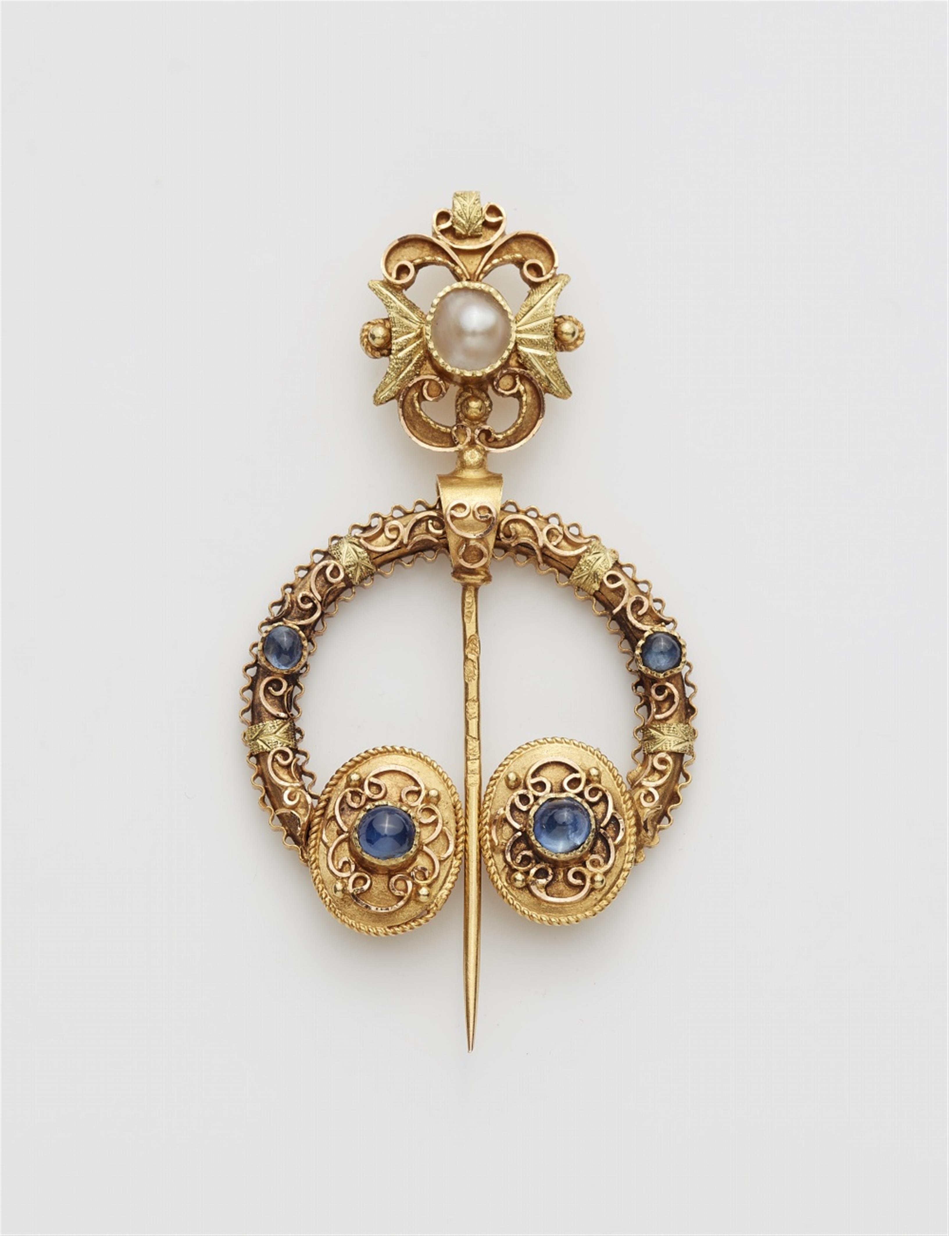 A 14k gold Celtic style fibula brooch - image-1