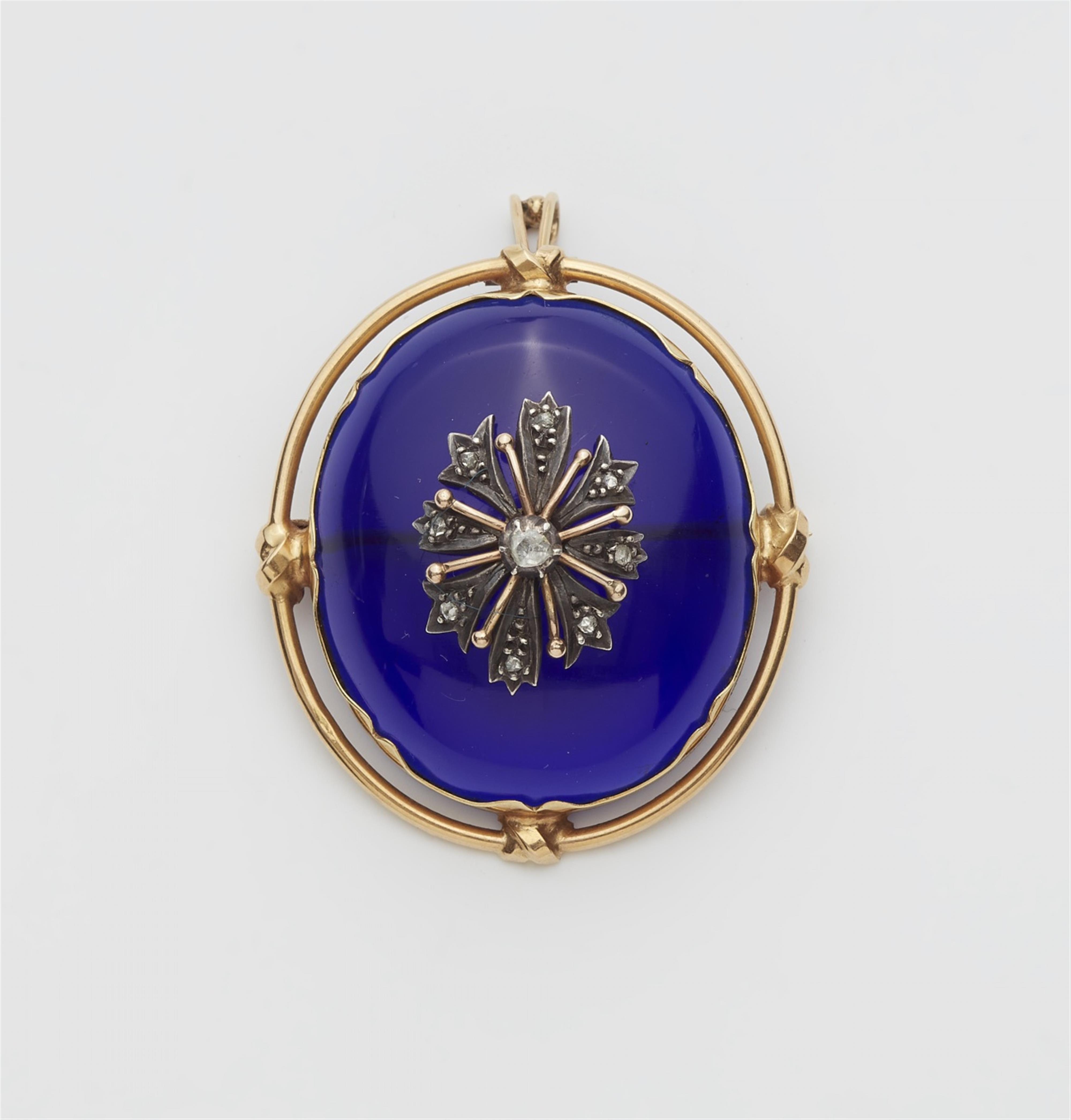 A 14k gold pendant brooch with a blue paste cabochon - image-1