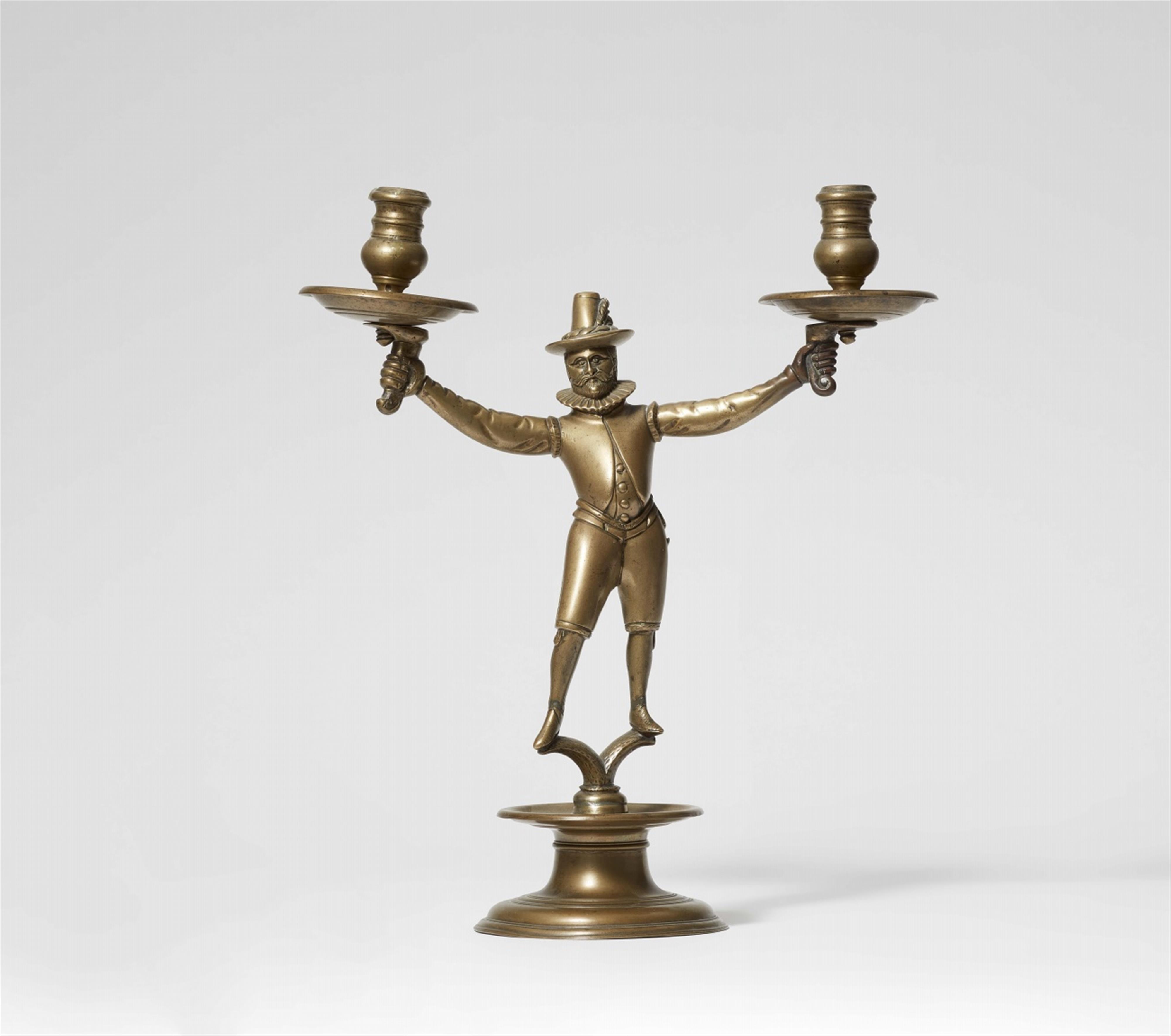 A brass chandelier with a male figure - image-1