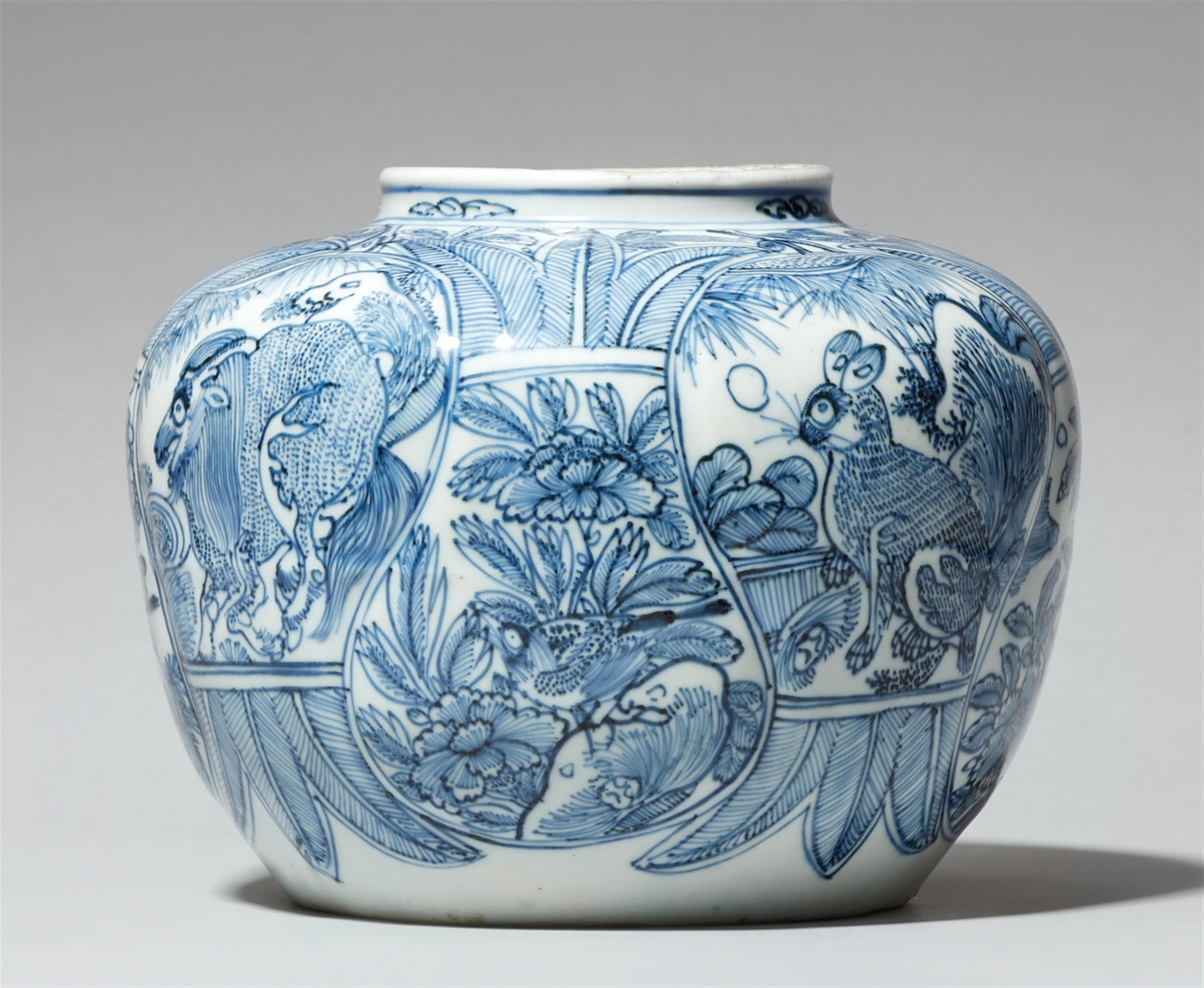 A small blue and white jar. - image-1