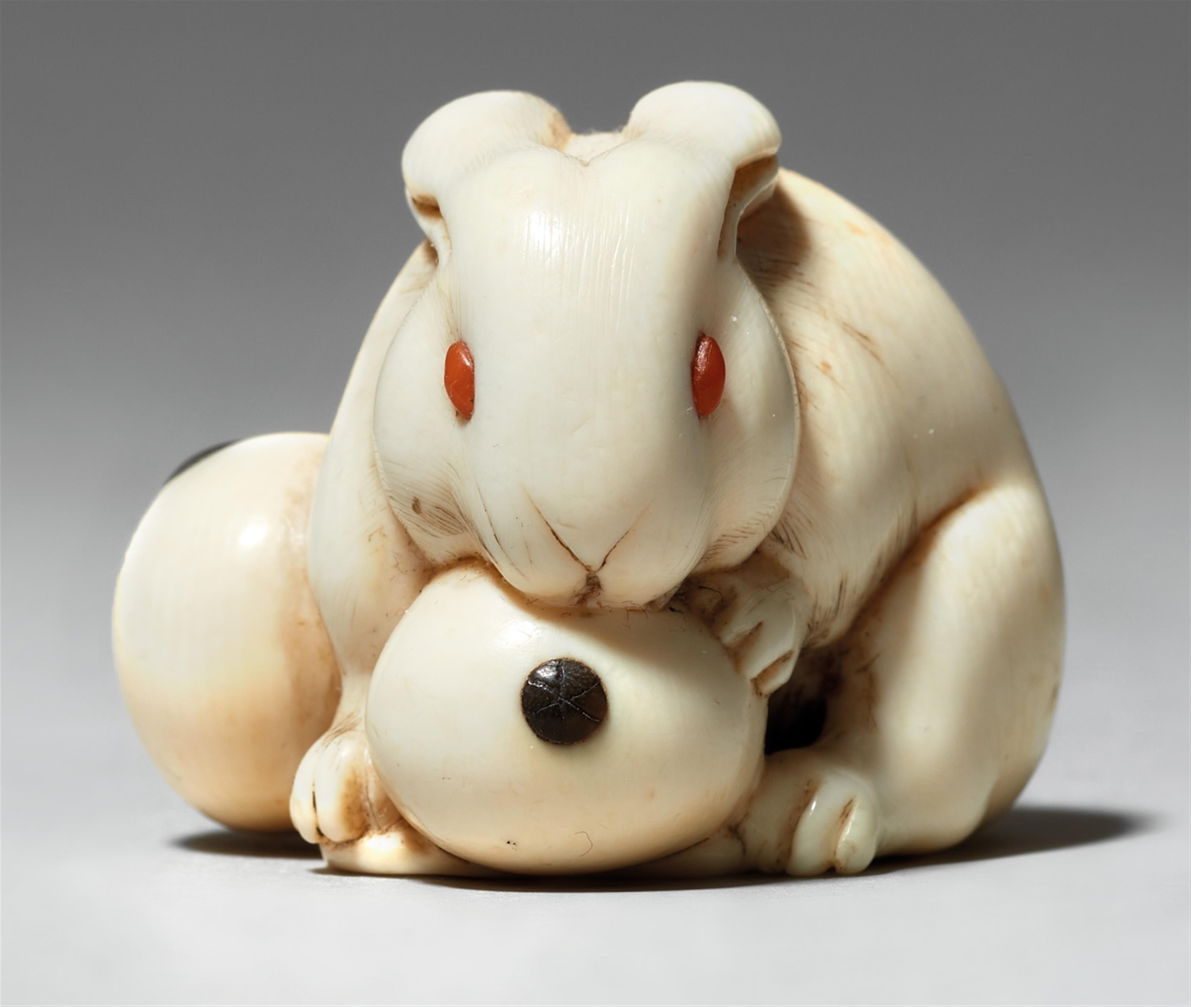 An ivory netsuke of a hare with a biwa-fruit. Second half 19th century - image-1