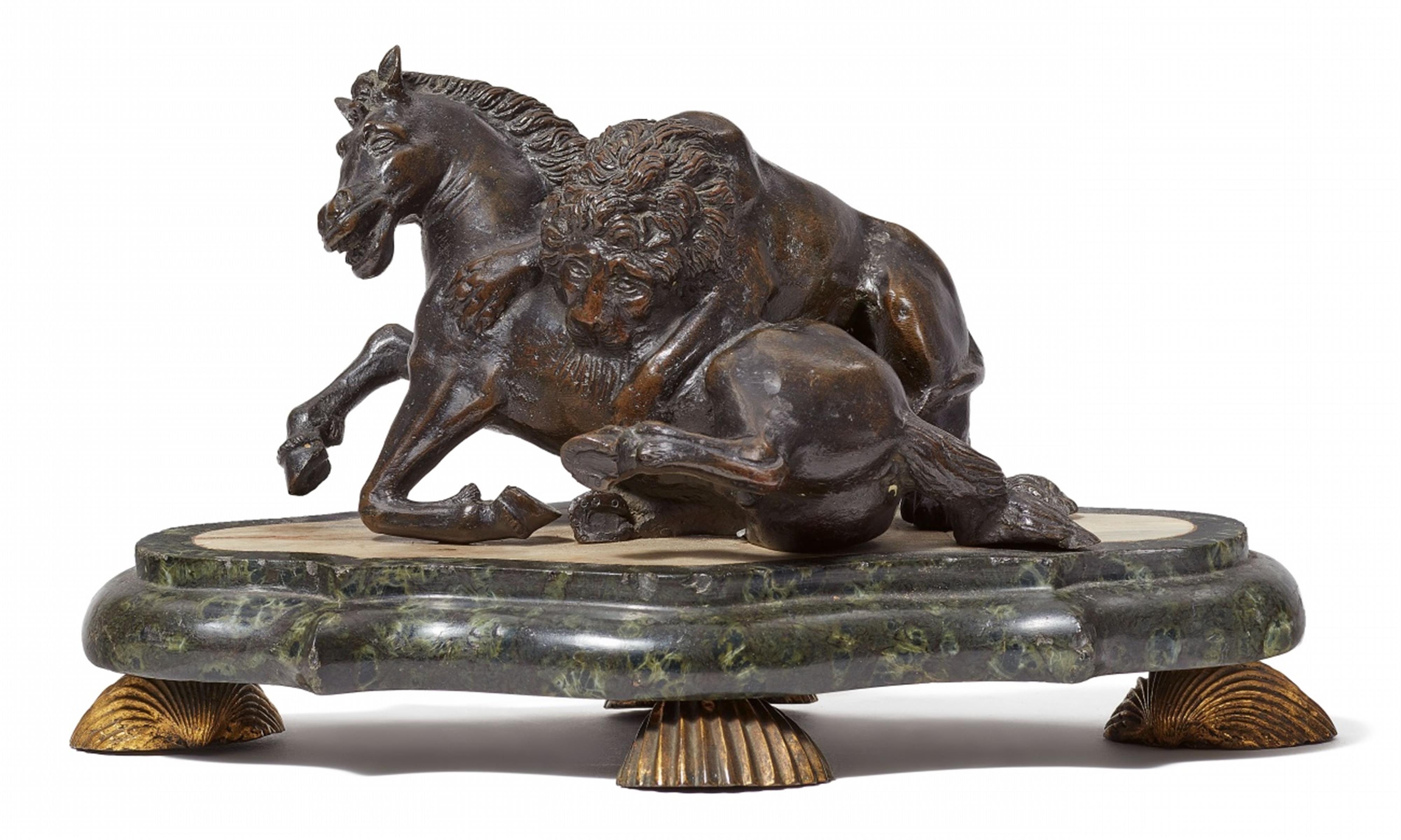 A bronze model of a lion attacking a horse - image-1