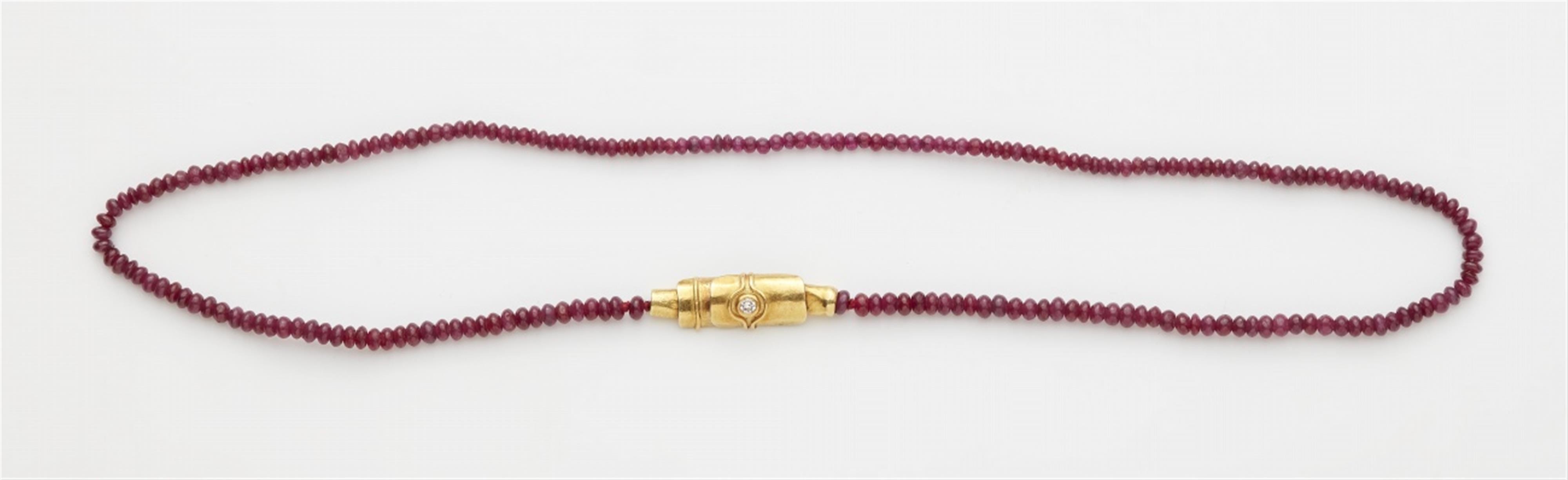 An 18k gold ruby necklace with a diamond clasp - image-1