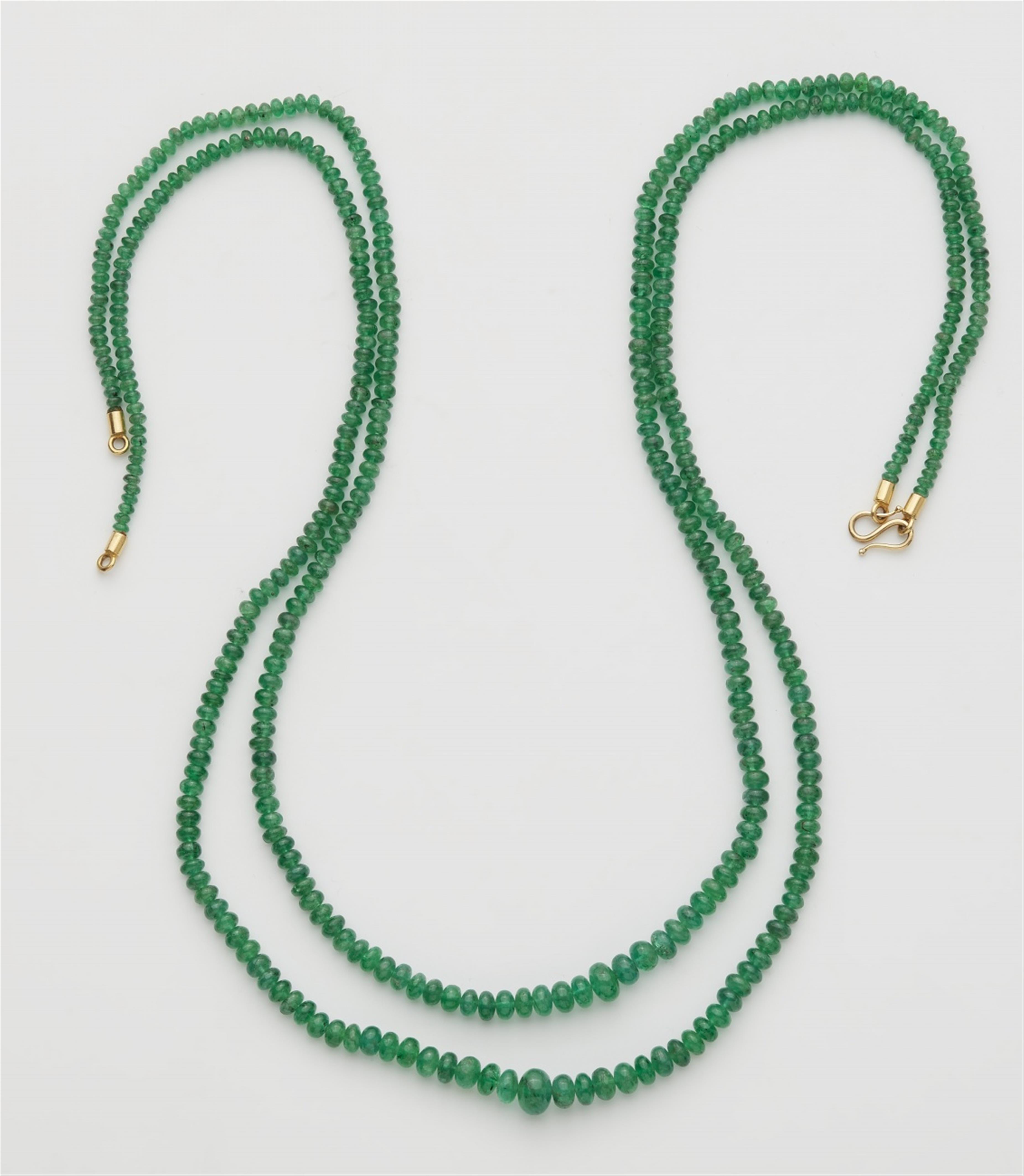 An 18k gold double stranded emerald necklace - image-1