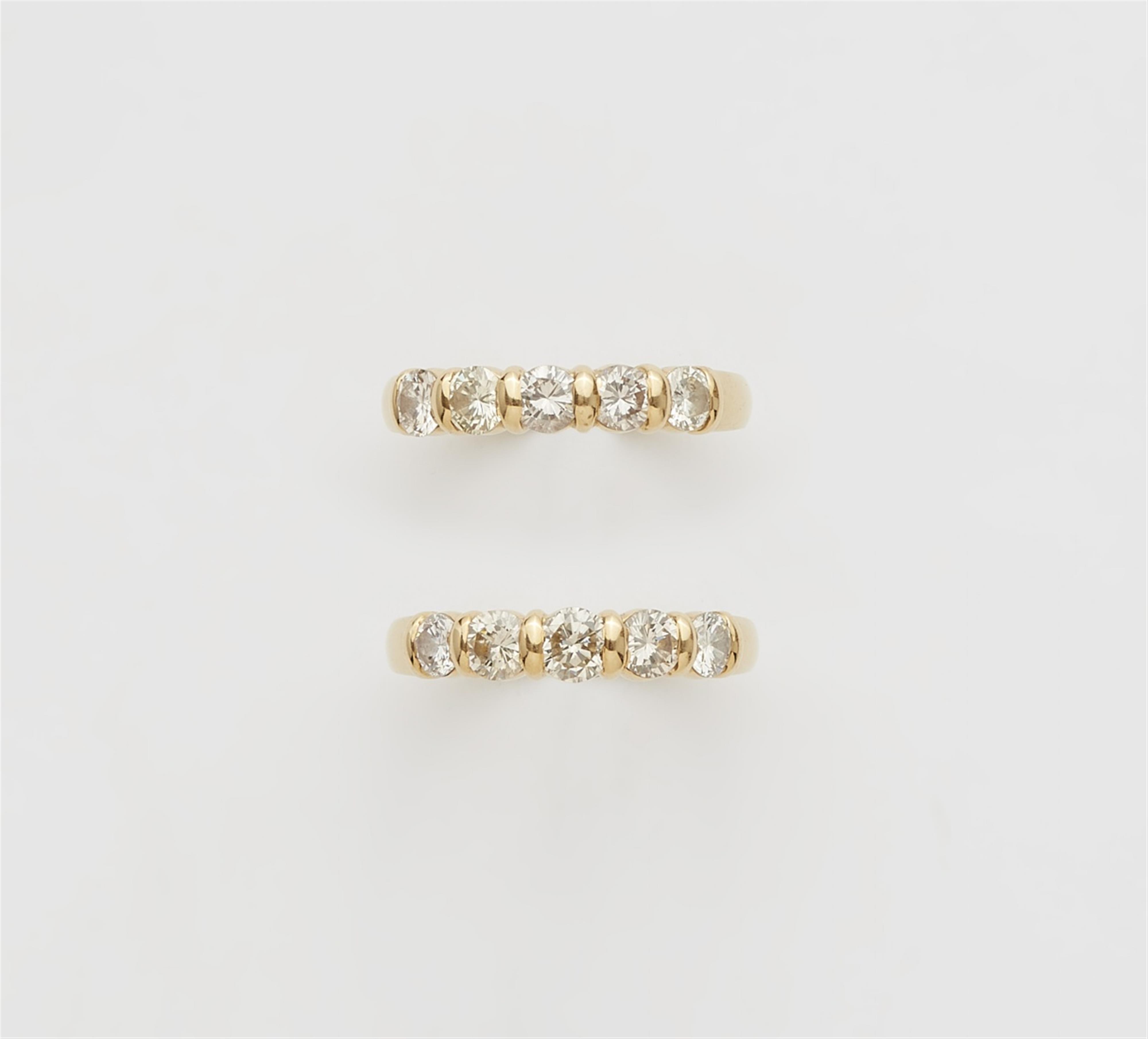 A pair of 18k gold five-stone diamond rings - image-1